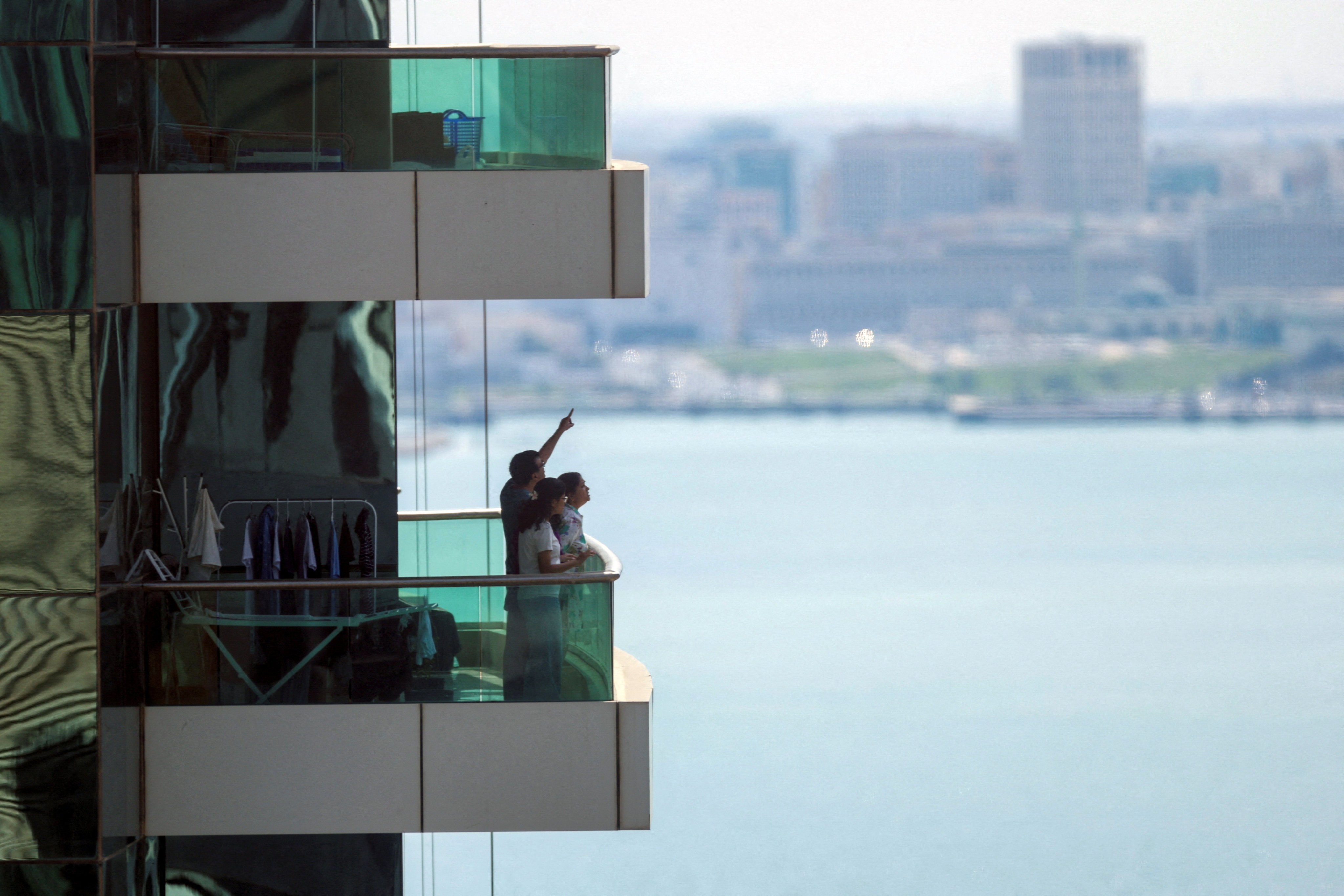 People watch from their balcony in Doha after Qatar’s defence ministry said it downed missiles targeting the country. Photo: Reuters
