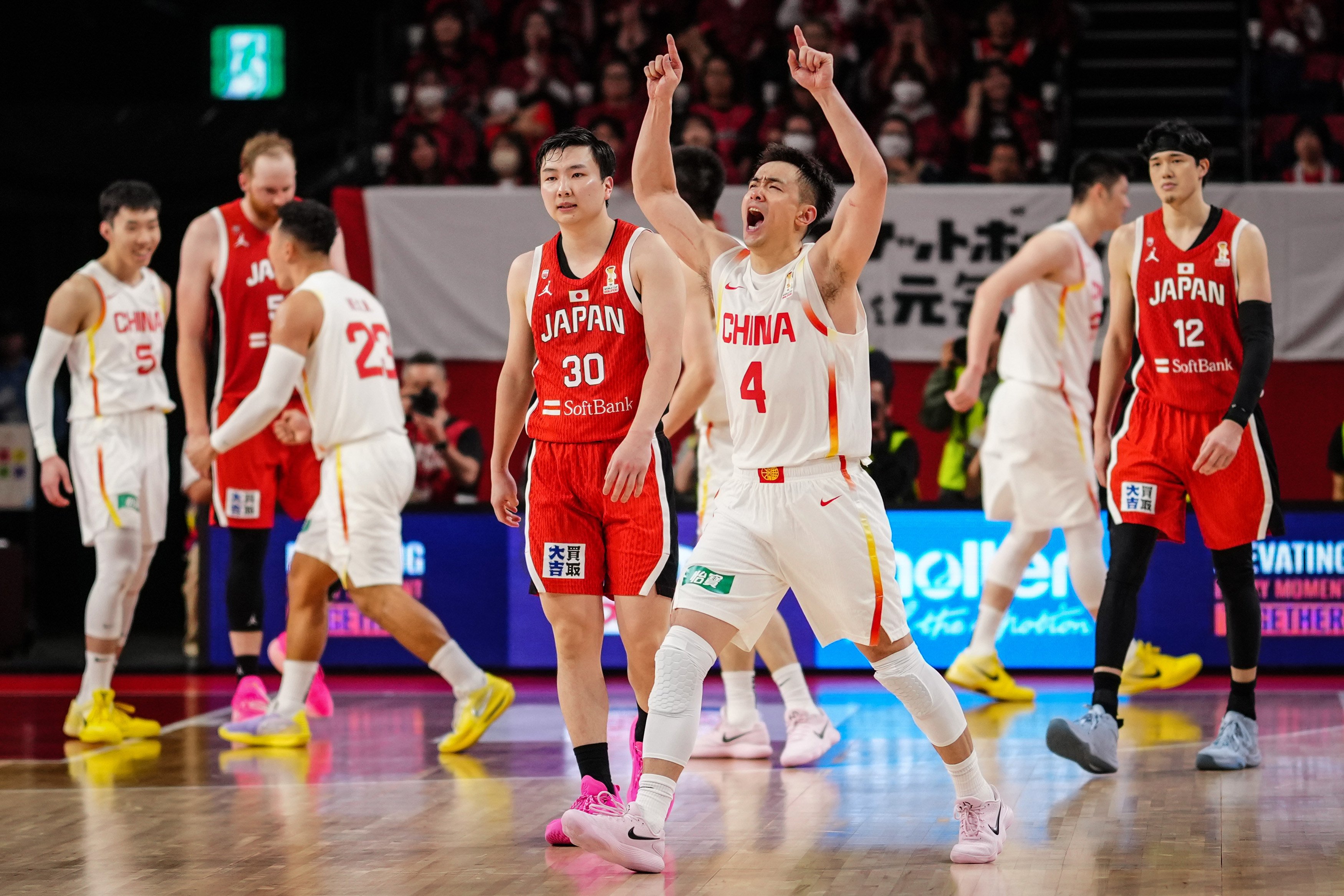 Zhao Jiwei (front) and his China teammates celebrate after their win over Japan at the Fiba World Cup Asian Qualifiers in Okinawa on Thursday. Photo: Xinhua