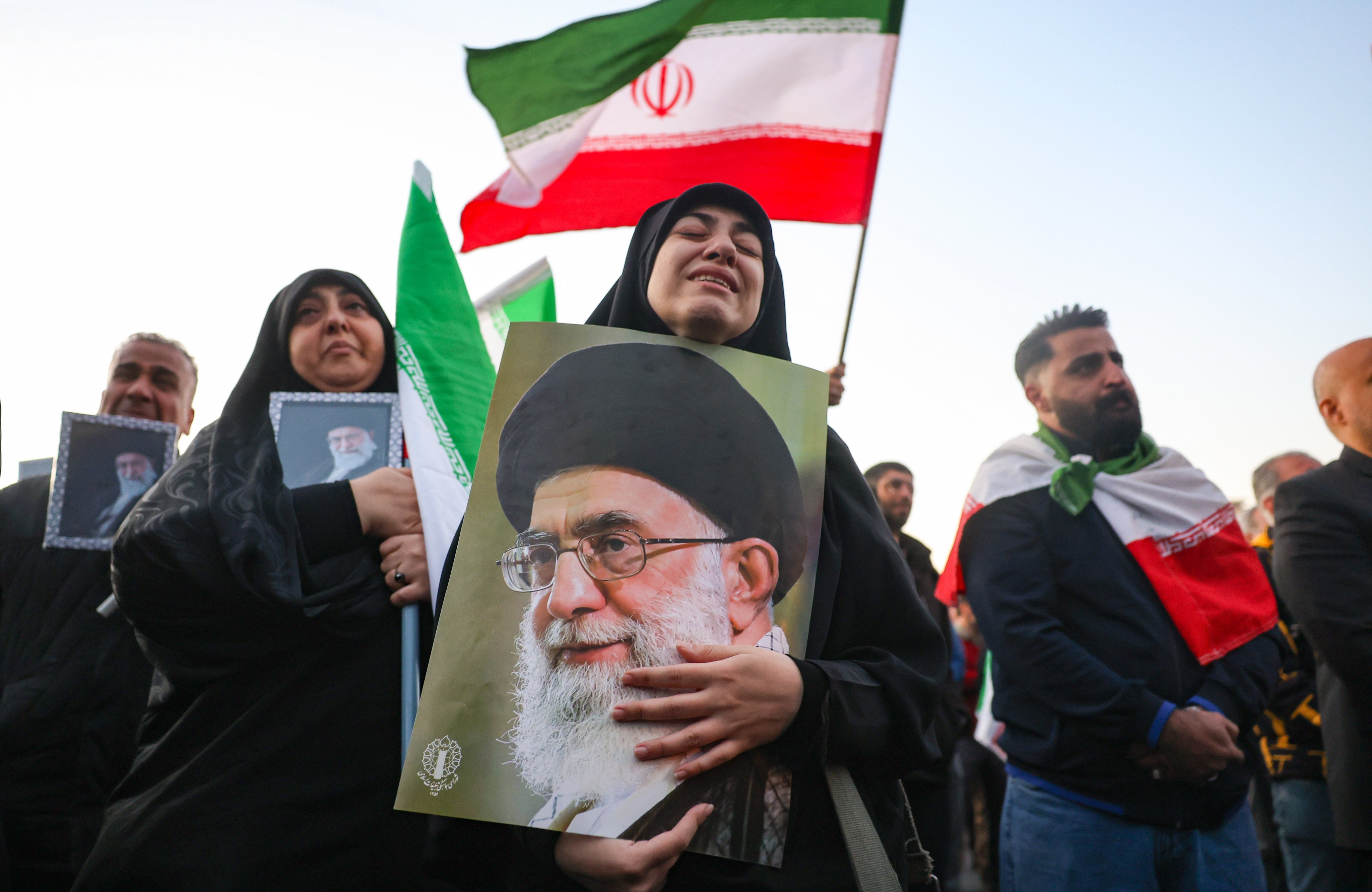 Mourners hold pictures of Ayatollah Ali Khamenei, the Iranian supreme leader  killed in US-Israeli air strikes, in Tehran on Sunday. Photo: EPA