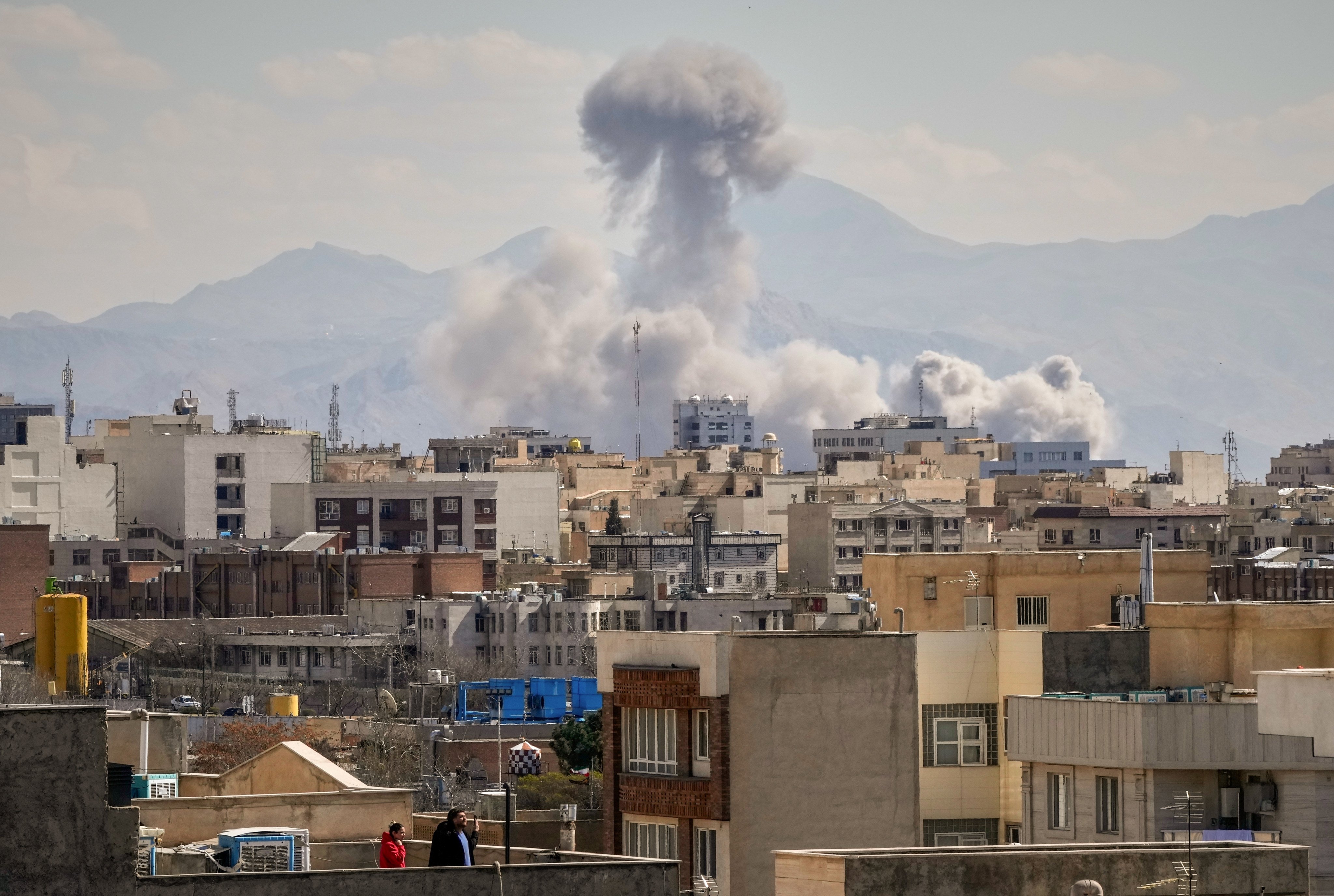 A plume of smoke rises after a strike in Tehran on Sunday. Photo: AP