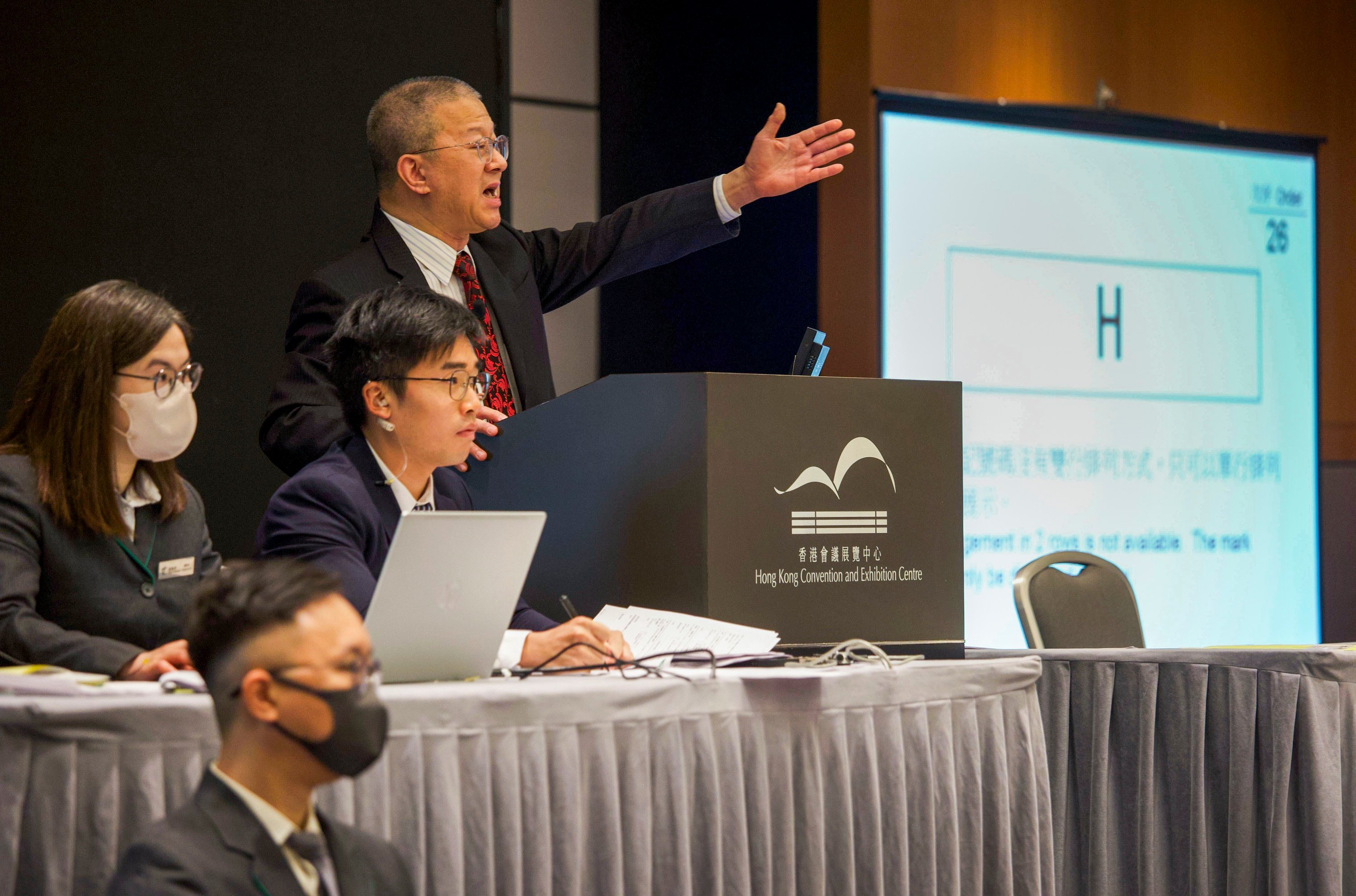 The auctioneer gestures as the “H” plate goes up for sale at the Hong Kong Convention and Exhibition Centre in Wan Chai. Photo: Handout