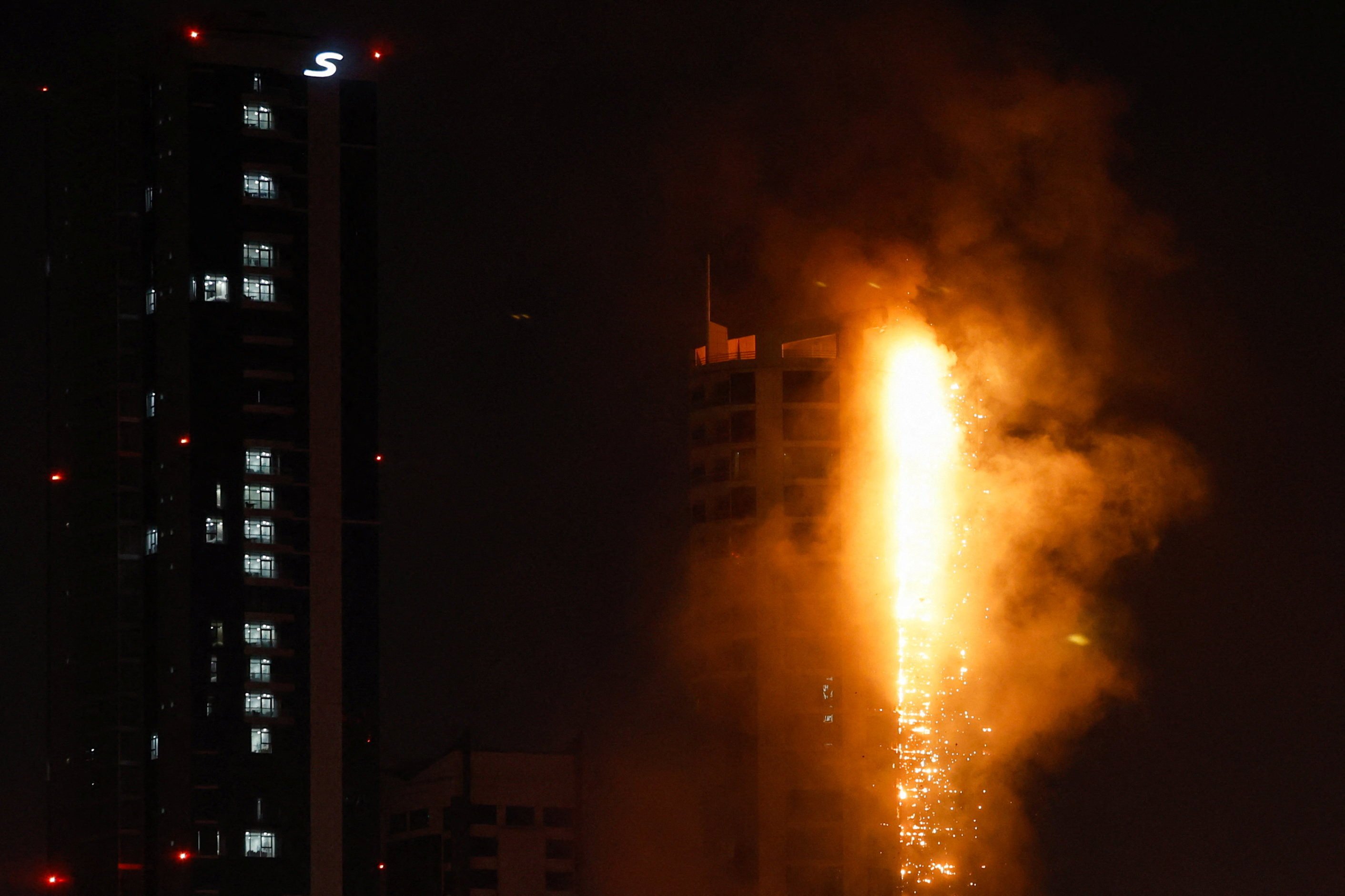 Smoke rises from a burning building hit by an Iranian drone strike in Seef district, Manama, Bahrain. Photo: Reuters