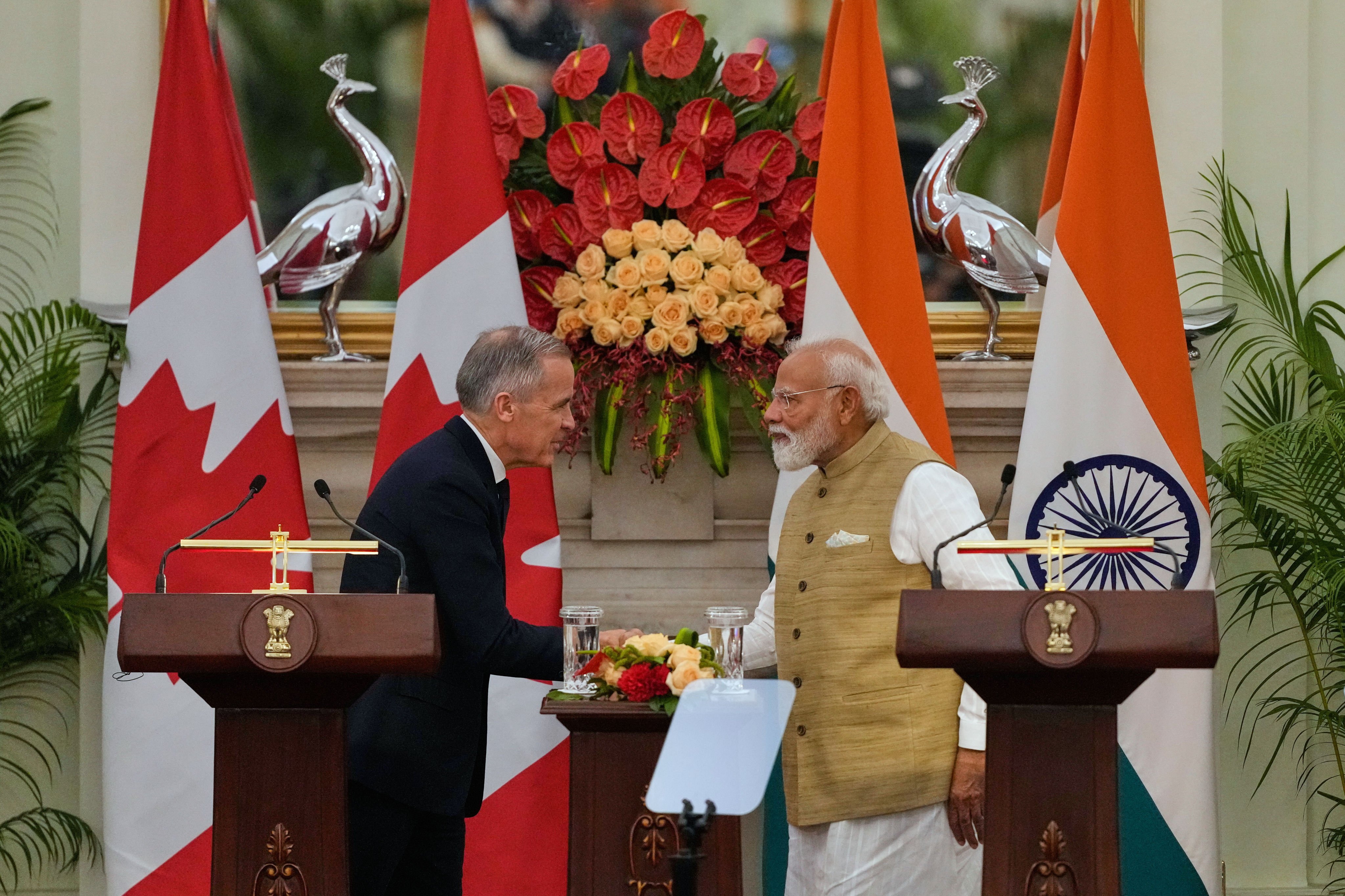 India Prime Minister Narendra Modi, right, shakes hands with his Canadian counterpart Mark Carney in New Delhi on Monday. Photo: AP