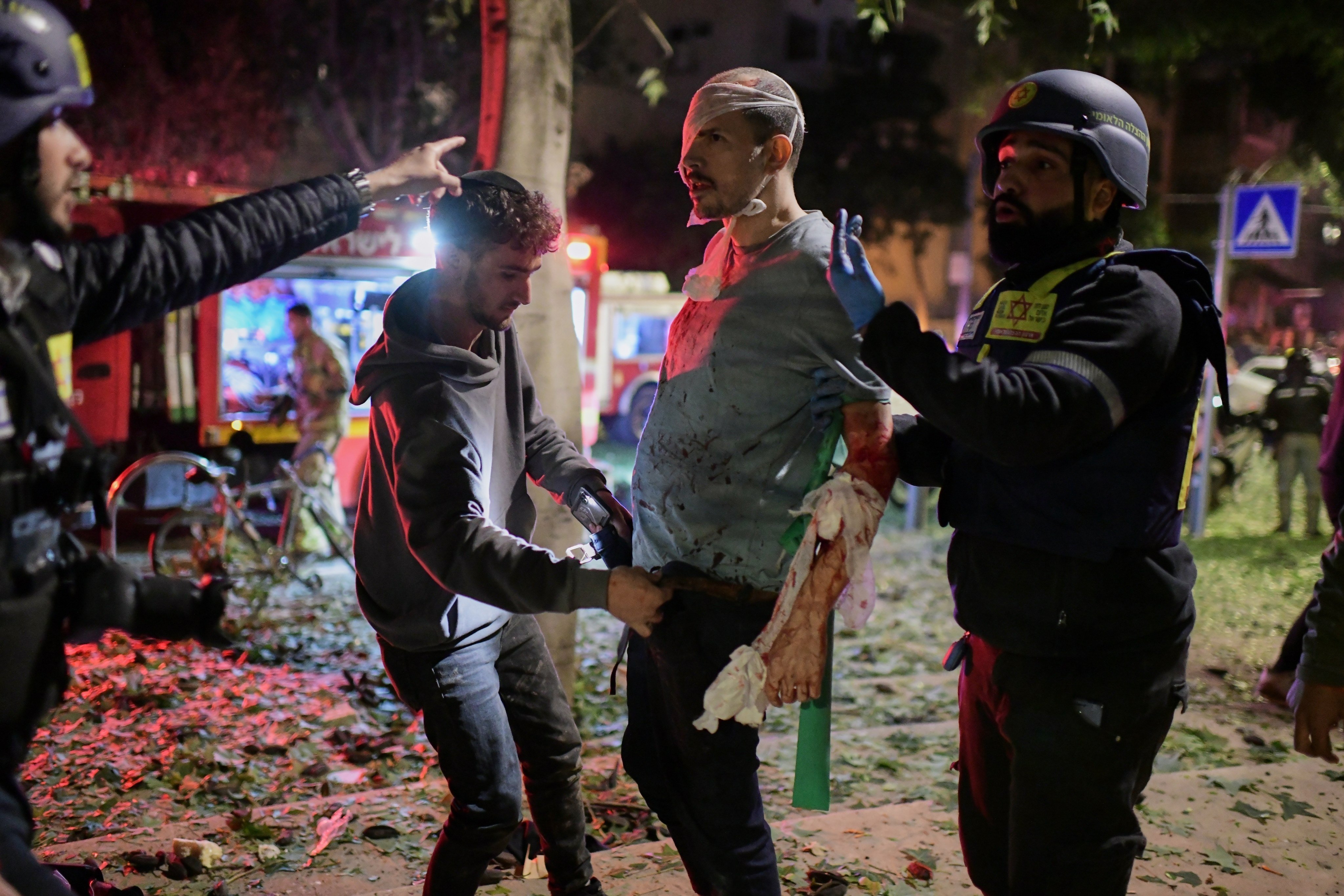 Rescue workers attend to a wounded man at a site struck by an Iranian missile in Tel Aviv, Israel, on Saturday. Photo: AP