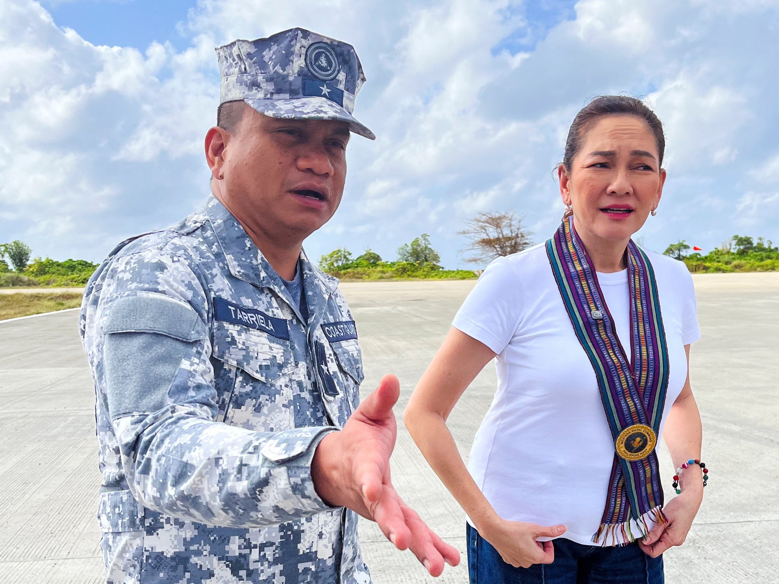 Philippine Coast Guard spokesman Jay Tarriela gestures beside Senator Risa Hontiveros during a visit to Philippine-occupied Thitu island in the disputed South China Sea on February 21. Photo: Reuters