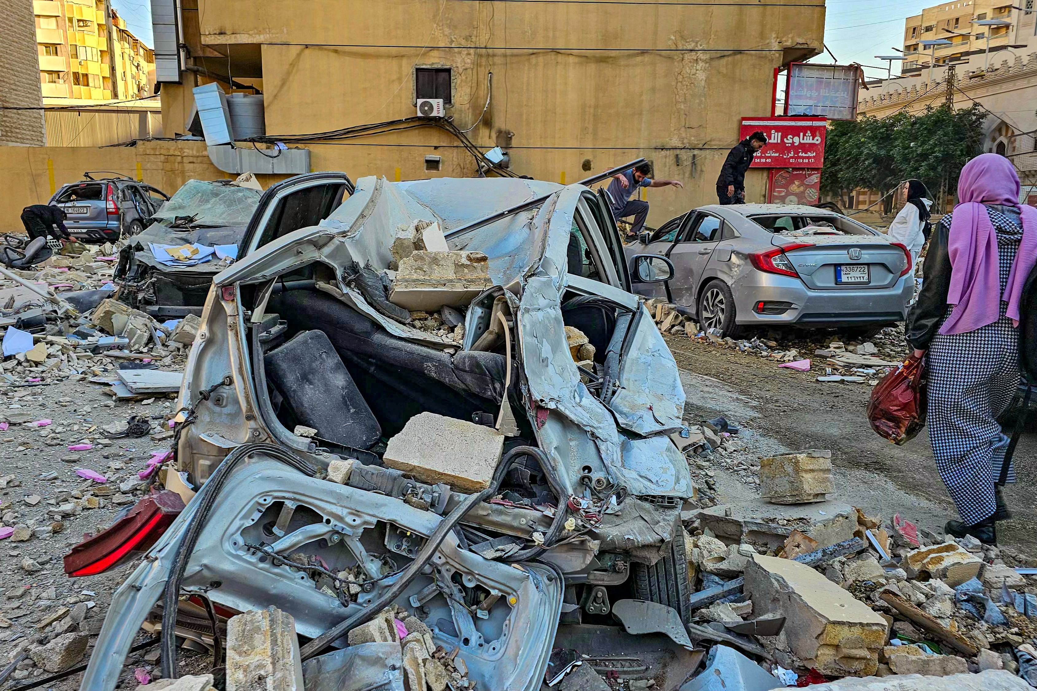 People check the wreckage after an Israeli air strike in the southern Beirut suburb of Haret Hreik on Monday, amid fears of spreading conflict in the region. Photo: AFP
