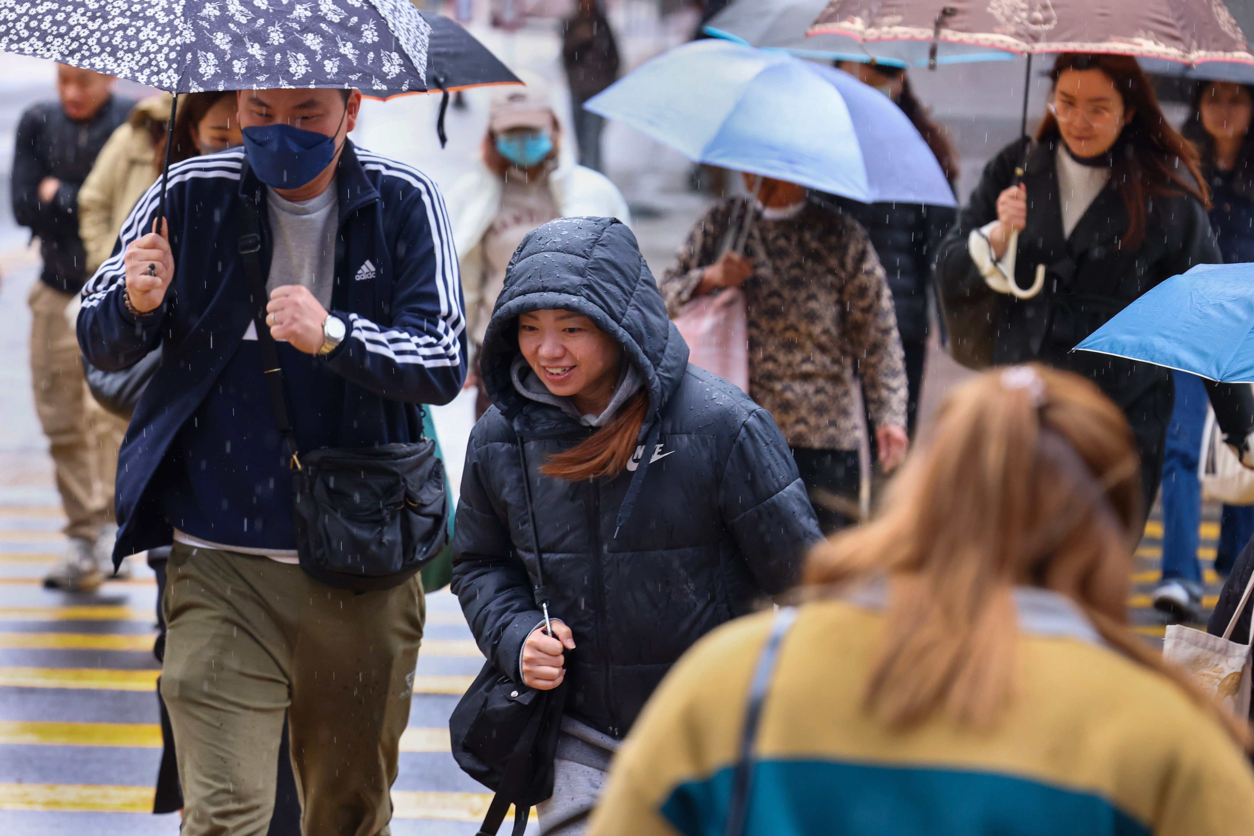 People in Mong Kok navigating the rainy weather in March 2025. Photo: Dickson Lee