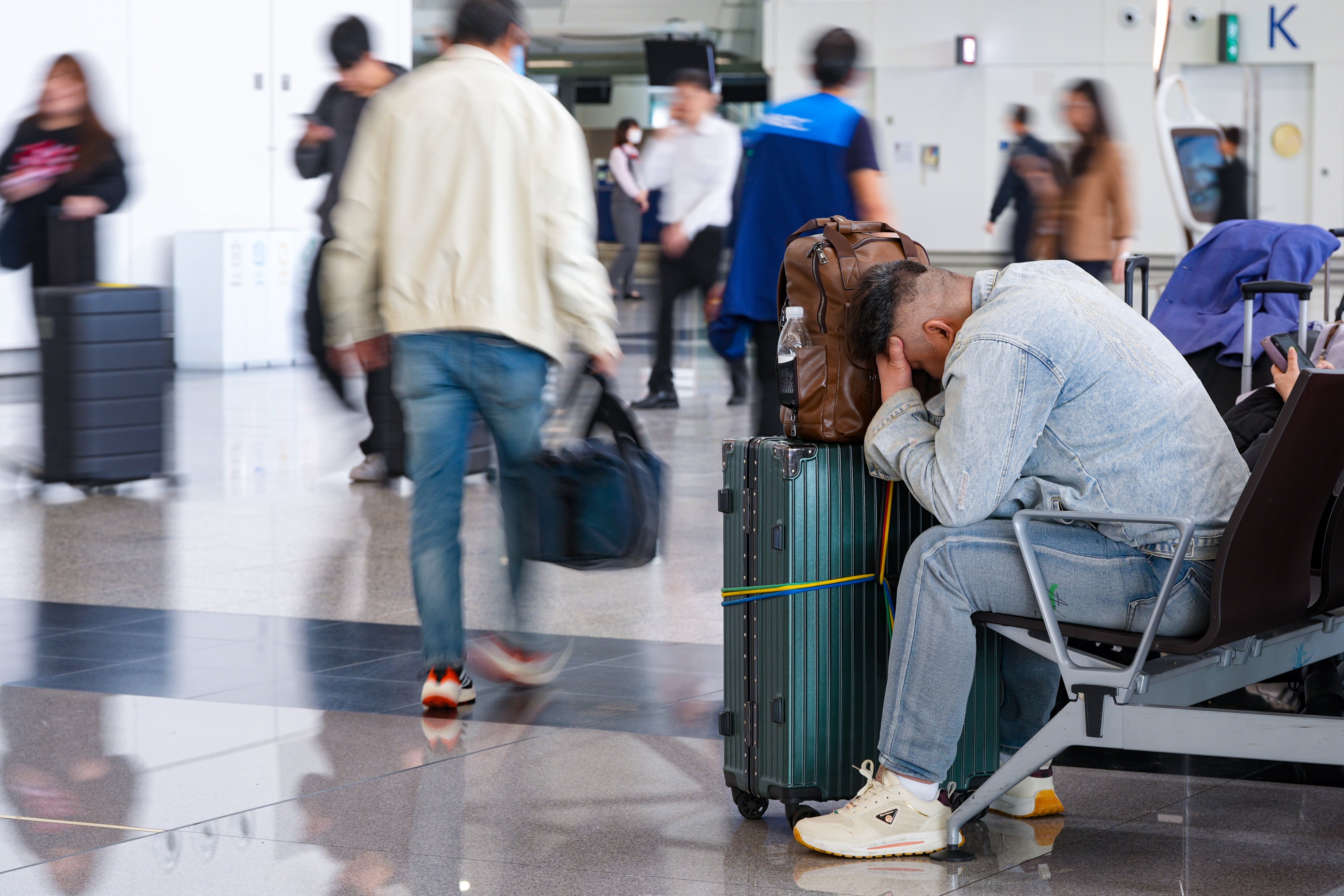Travellers at Hong Kong International Airport in Chek Lap Kok on Monday afternoon. Cathay Pacific halts Dubai and Riyadh flights until Thursday amid US-Israeli strikes on Iran. 02MAR26. SCMP / Eugene Lee