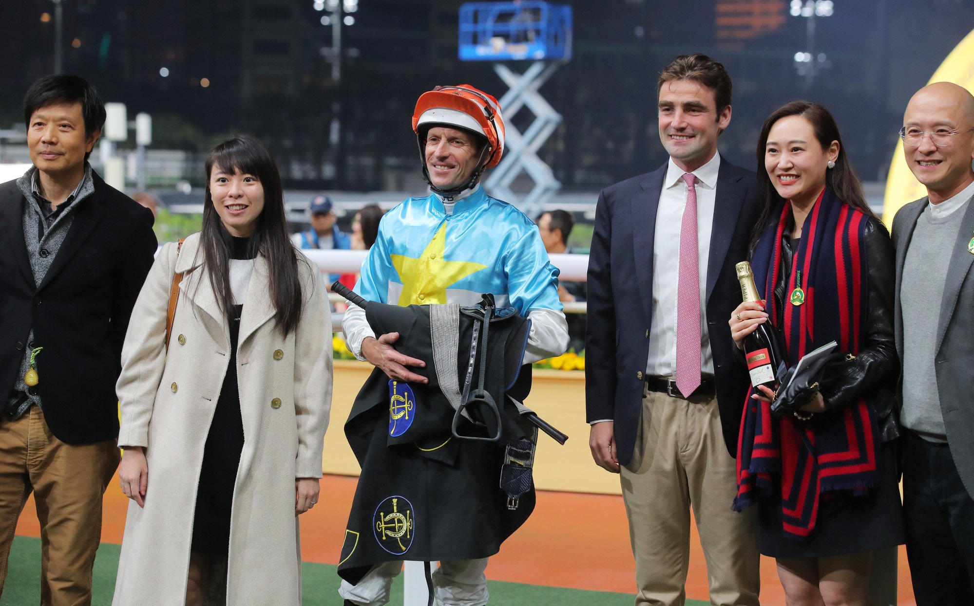 Jockey Hugh Bowman, trainer David Eustace (third from right) and connections of Ragga Bomb celebrate his recent win.