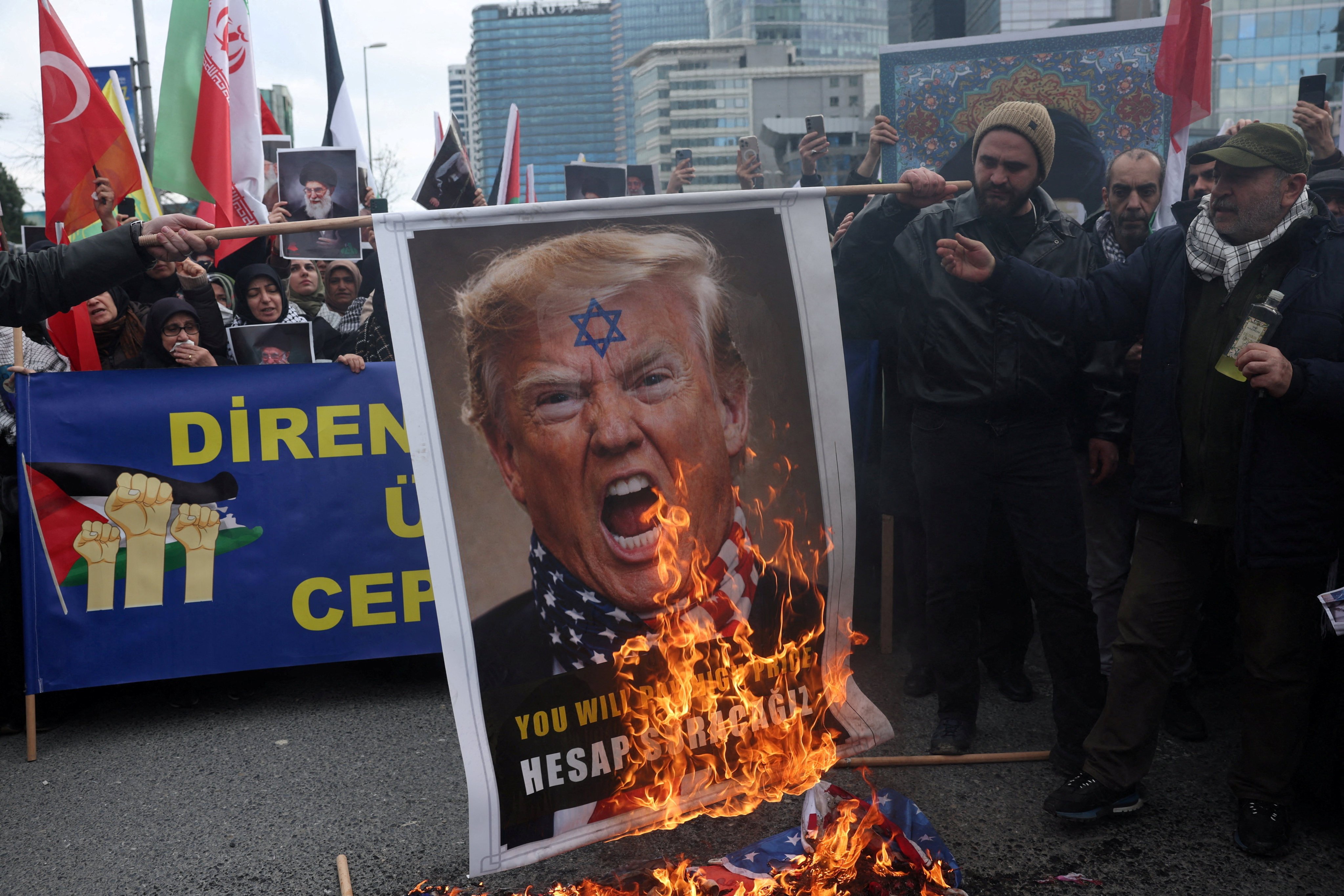 Demonstrators outside the Israeli consulate in Istanbul, Turkey, set fire to a placard with a picture of US President Donald Trump on Sunday. Photo: Reuters