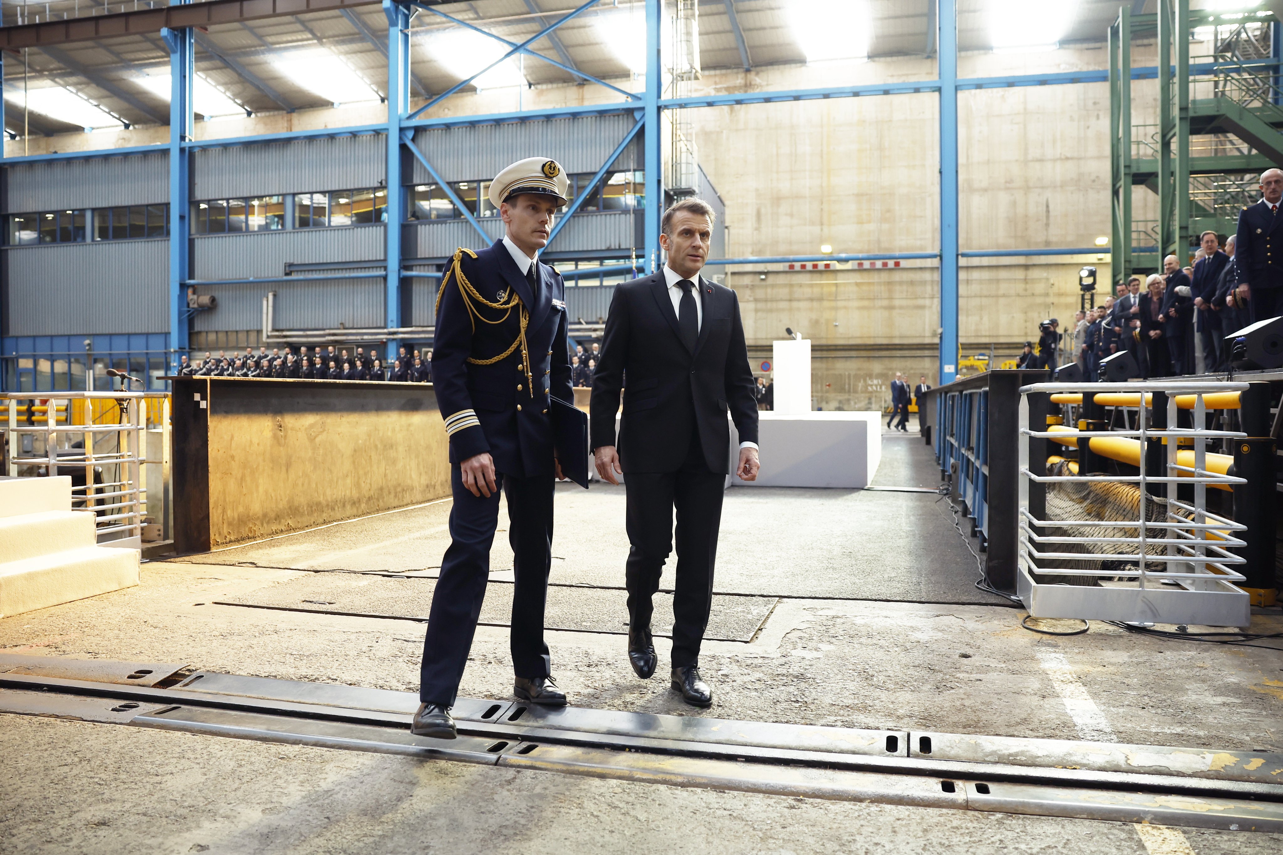 French President Emmanuel Macron, right, with an official at the nuclear submarines naval base of Ile Longue in Crozon, near Brest, France on Monday. Photo: EPA