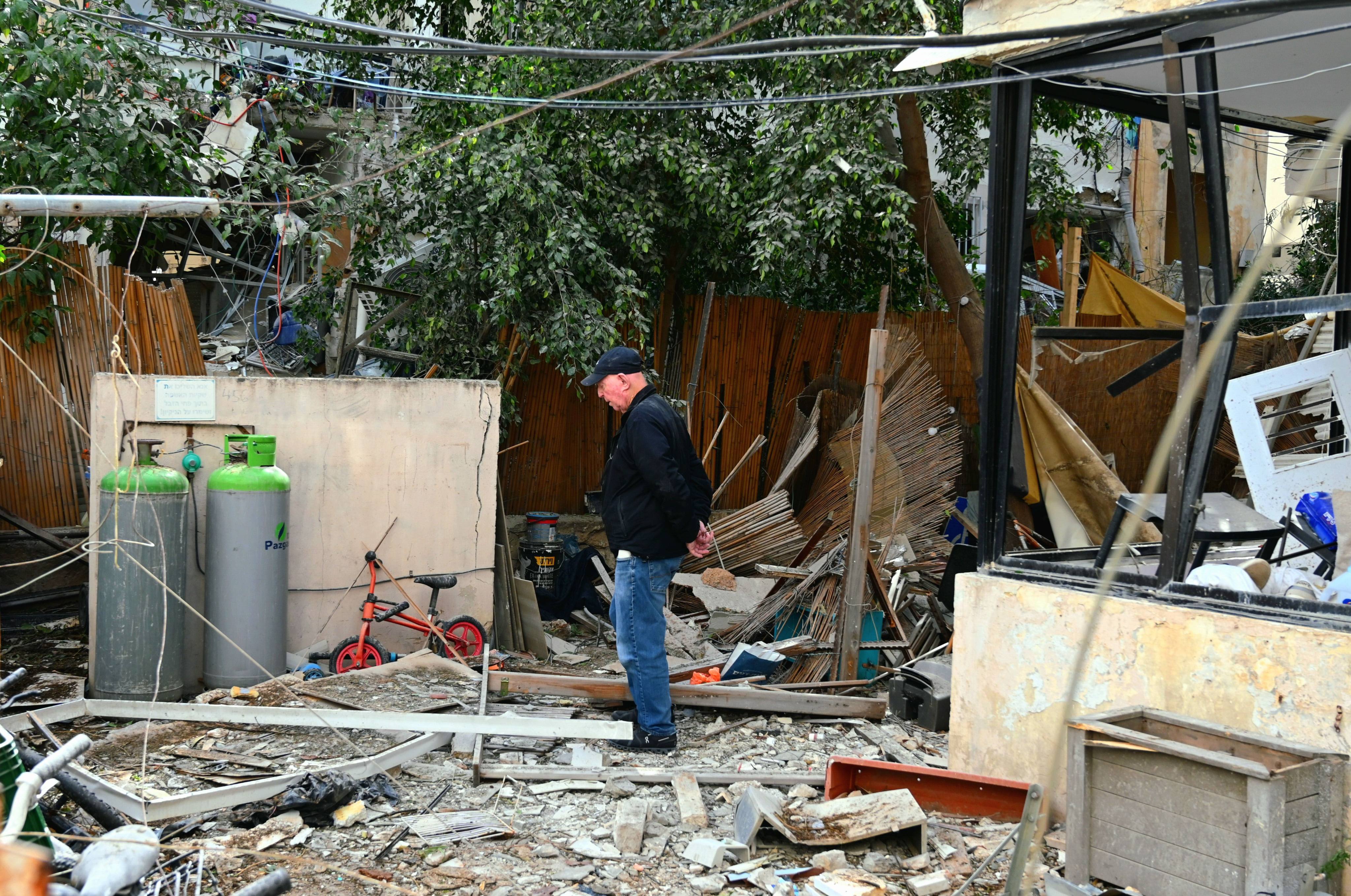 A resident inspects damage at his home in Tel Aviv on Sunday after a direct missile strike hit the area. Photo: dpa