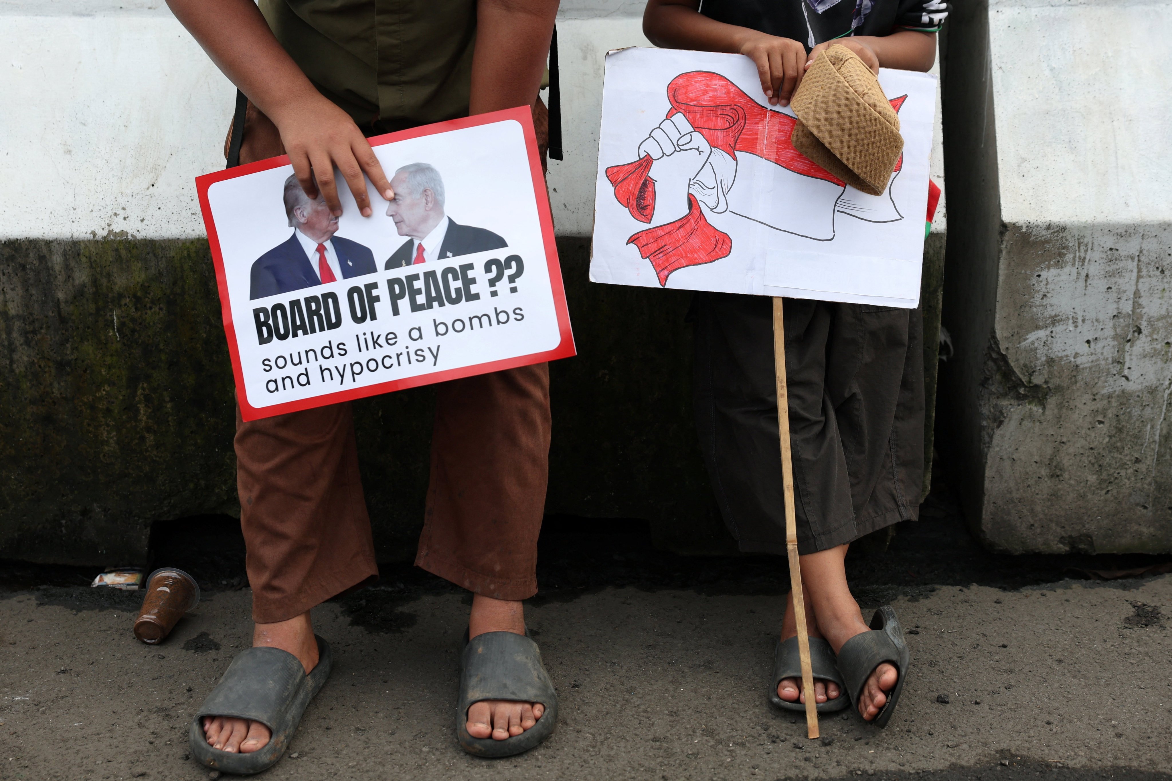 Young Indonesians hold signs as they take part in a protest against Israel outside the US embassy in Jakarta last month. Photo: Reuters