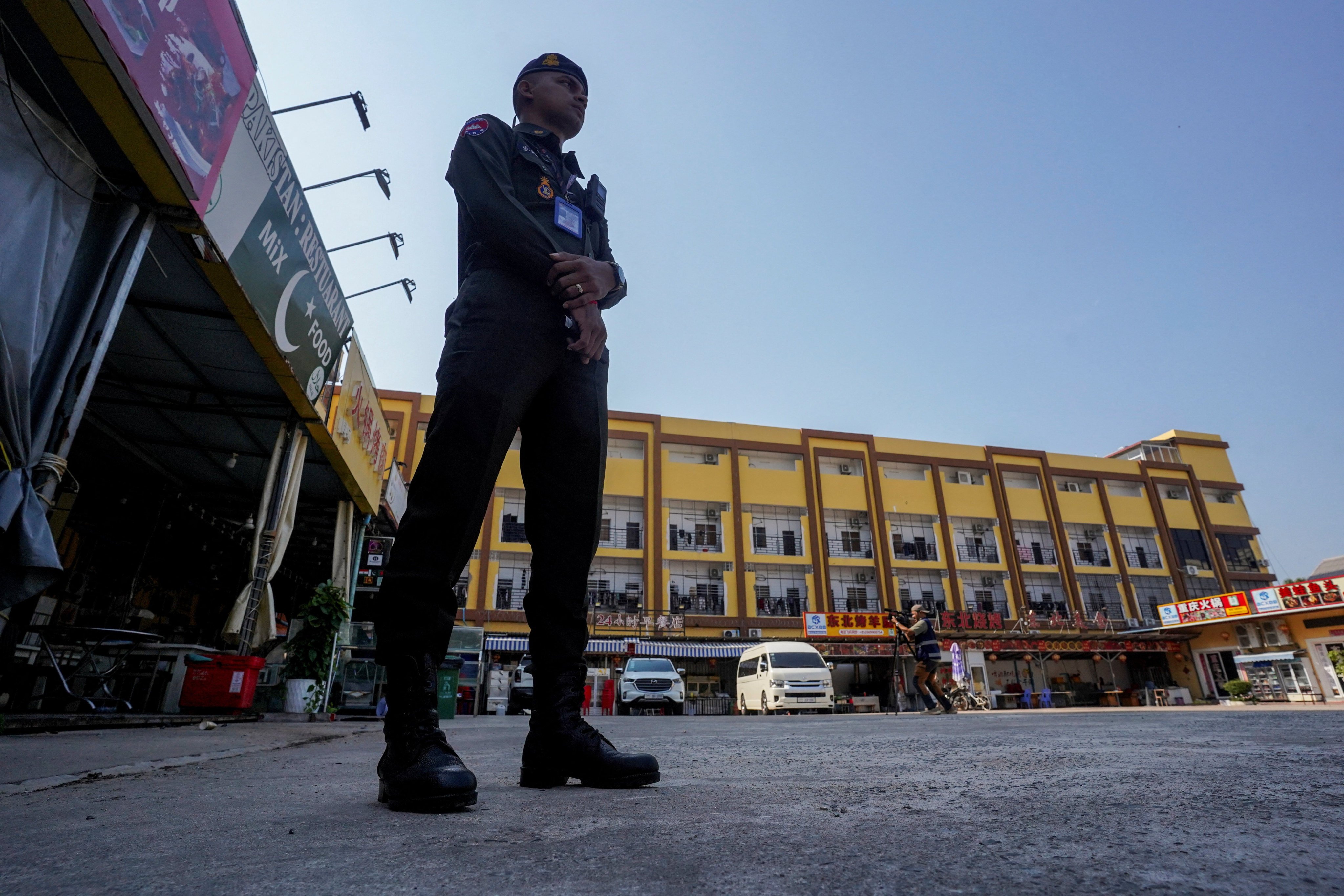 A Cambodian police officer stands guard near a scam compound in Kampot province, Cambodia, on February 10. Photo: Reuters