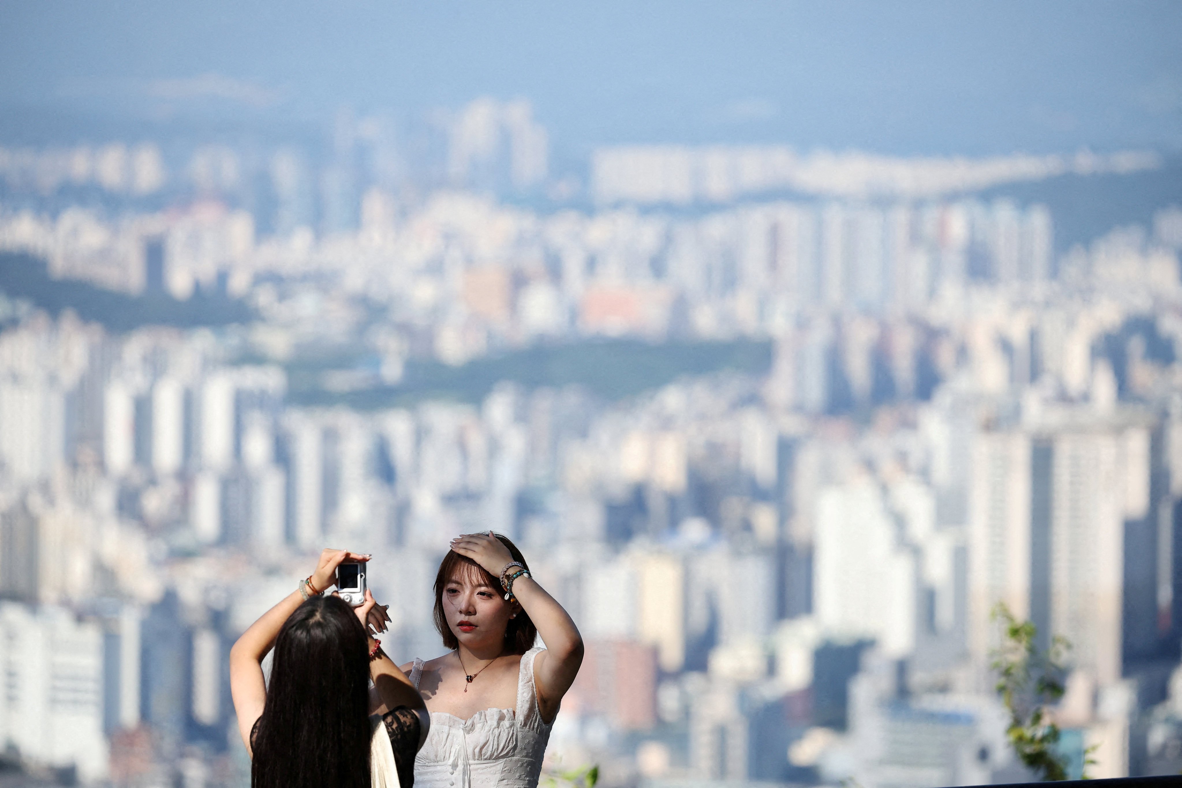 A woman poses for photographs from an observation deck at N Seoul Tower in Seoul, South Korea. South Korea had shot down Google’s previous bids in 2007 and 2016 to be allowed to export the data, citing the risks that information ‌about sensitive military and security facilities could be exposed. Photo: Reuters