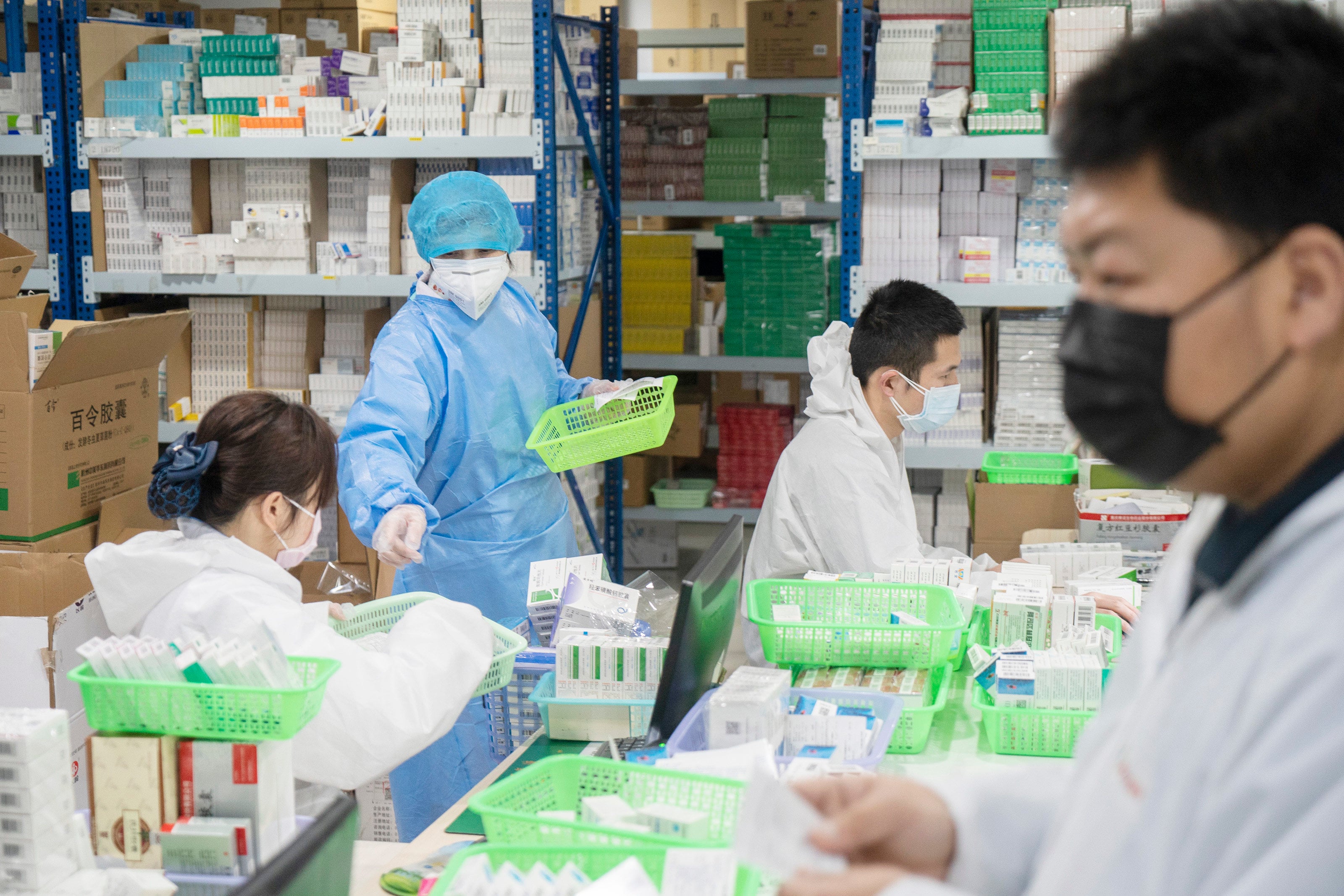 Staff members dispense medicines at a pharmacy in Wuhan, in central China’s Hubei province, on February 27, 2020. Photo: Xinhua