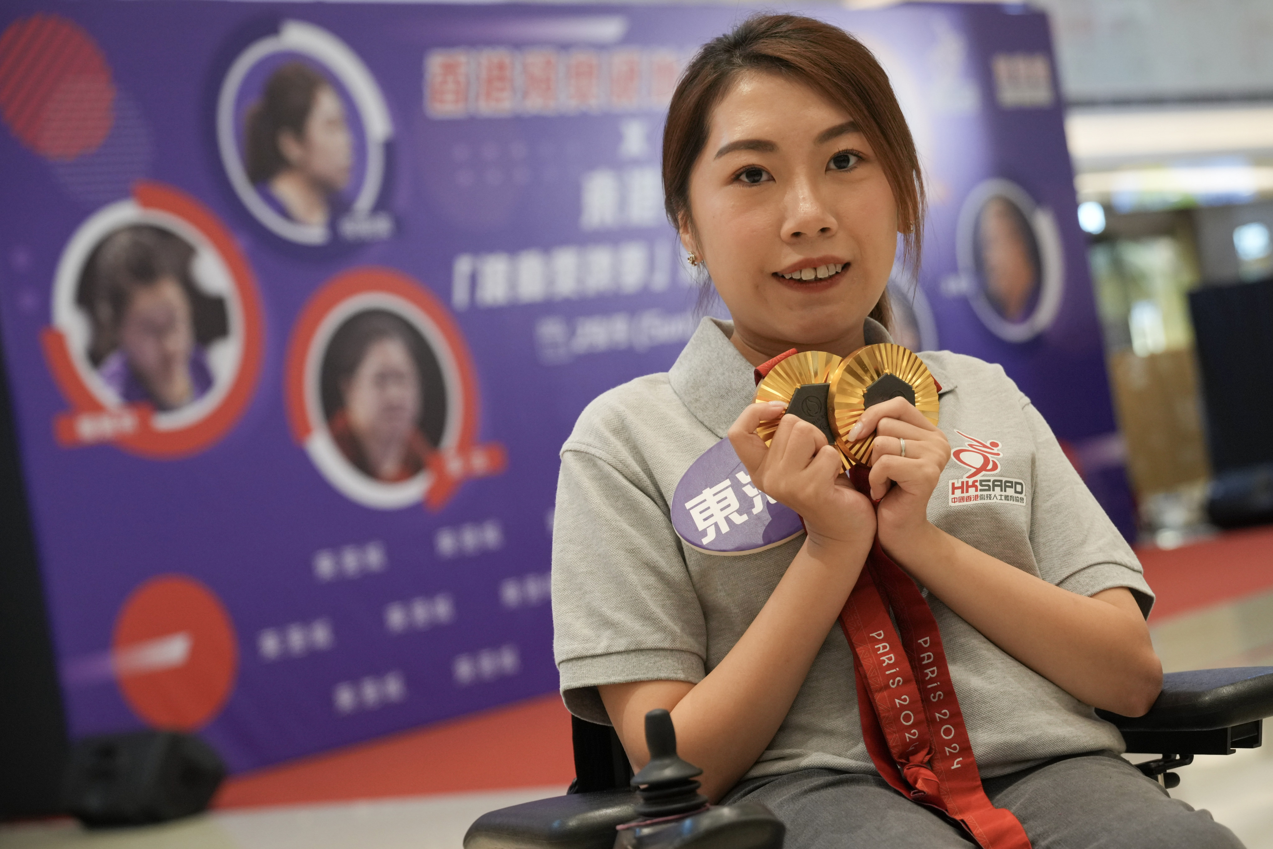 Hong Kong Paralympian Ho Yuen-kei holds her gold medals for boccia. Photo: May Tse