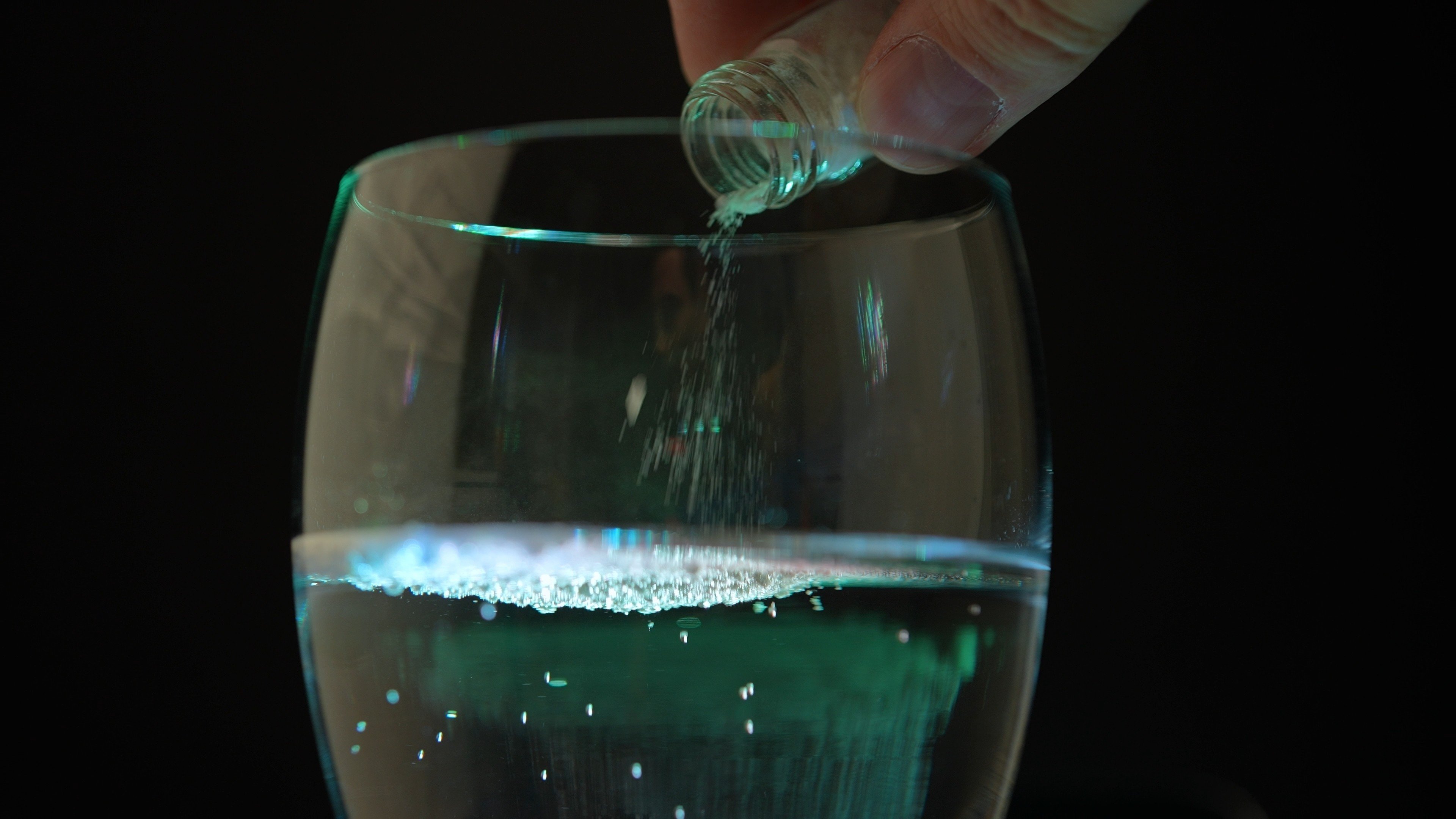 A person spiking an alcoholic drink. Photo: Shutterstock