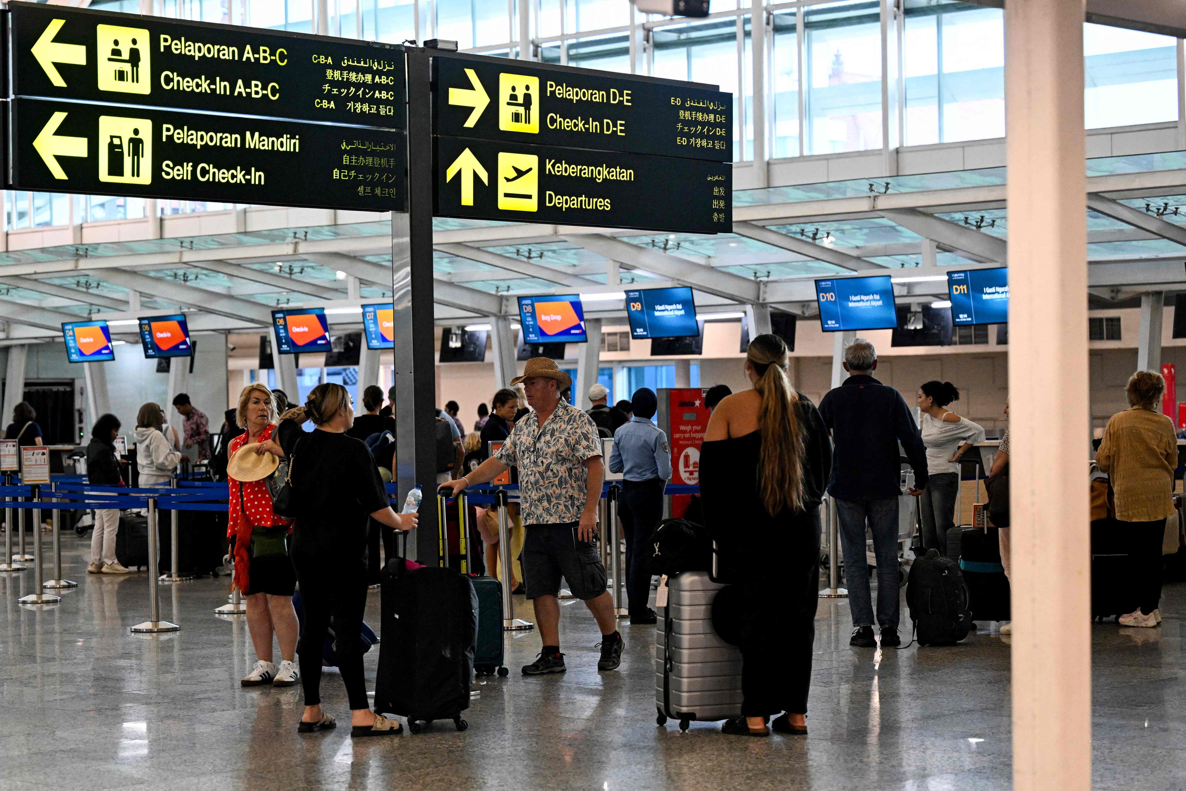 Passengers await news of their flights at Bali’s Ngurah Rai International Airport amid disruptions from  Israeli-US strikes on Iran on Monday. Photo: AFP