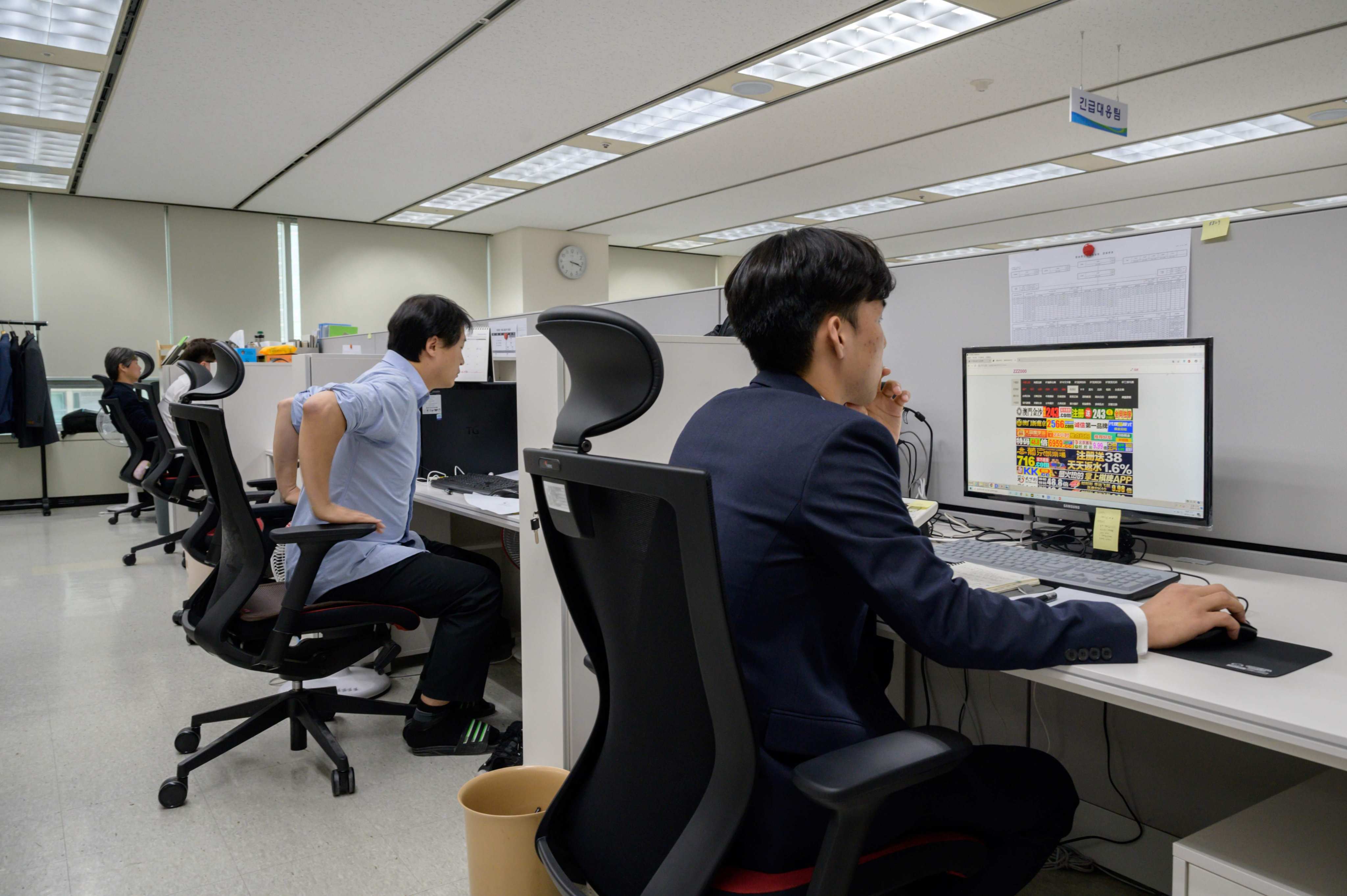 Officials at the Korea Communications Standards Commission hunt and remove sex videos posted without consent in 2019. The AI system helps ease the psychological burden on workers who previously had to review abusive content frame by frame. Photo: AFP