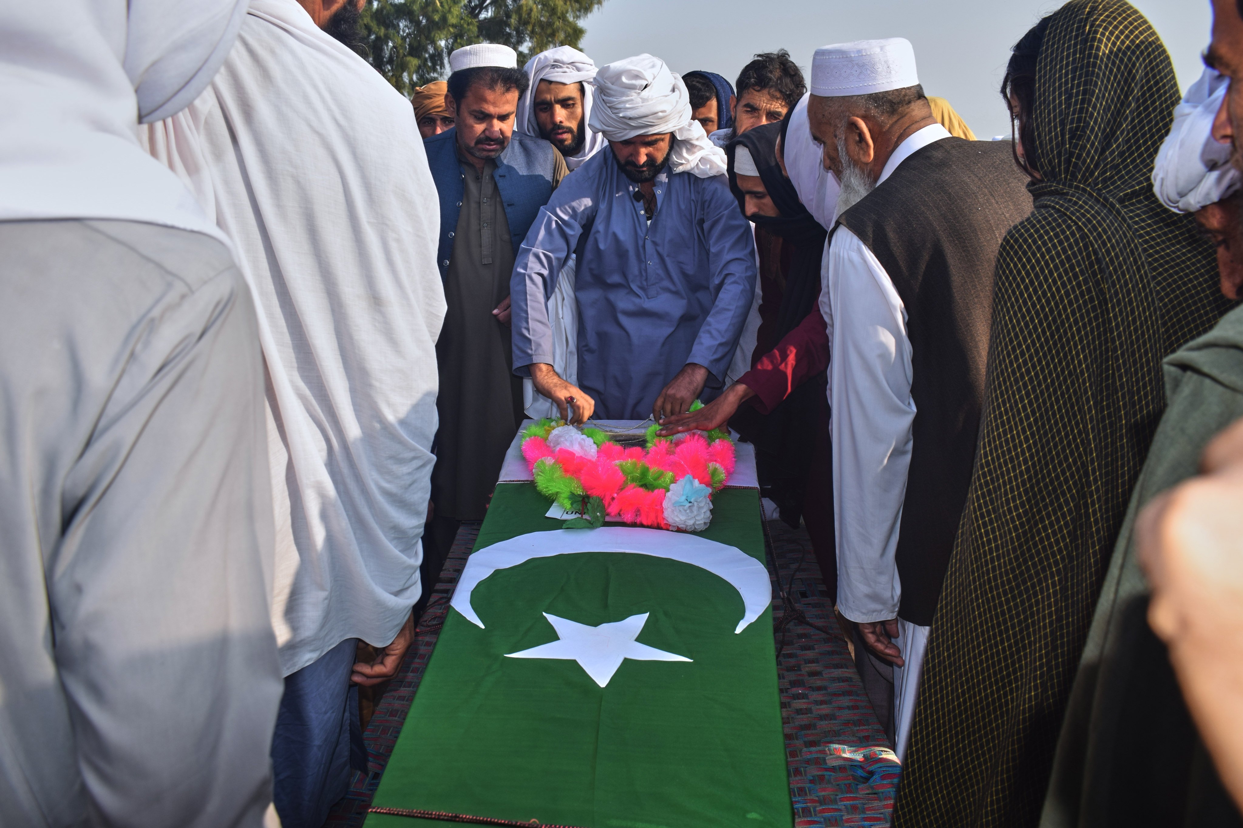 People gather around the coffin of an army soldier, killed in the border clashes between Pakistani and Afghan forces, during a funeral prayer in a village in Lakki Marwat, a district of Pakistan’s Khyber Pakhtunkhwa province on February 28. Photo: AP