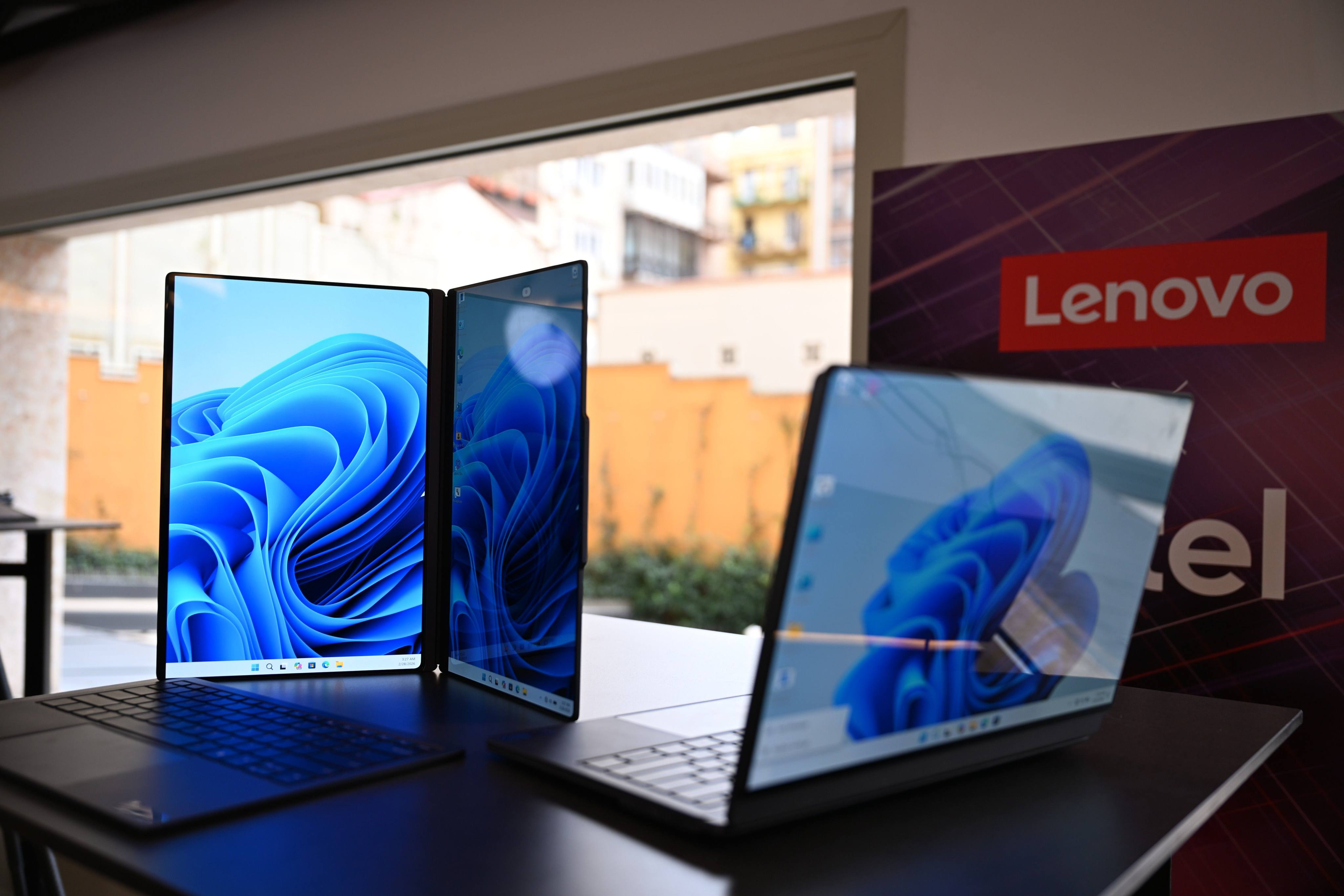 Dual-screen laptops from Chinese manufacturer Lenovo, still in the development stage, are displayed at MWC Barcelona 2026. Photo: Wolf von Dewitz/dpa