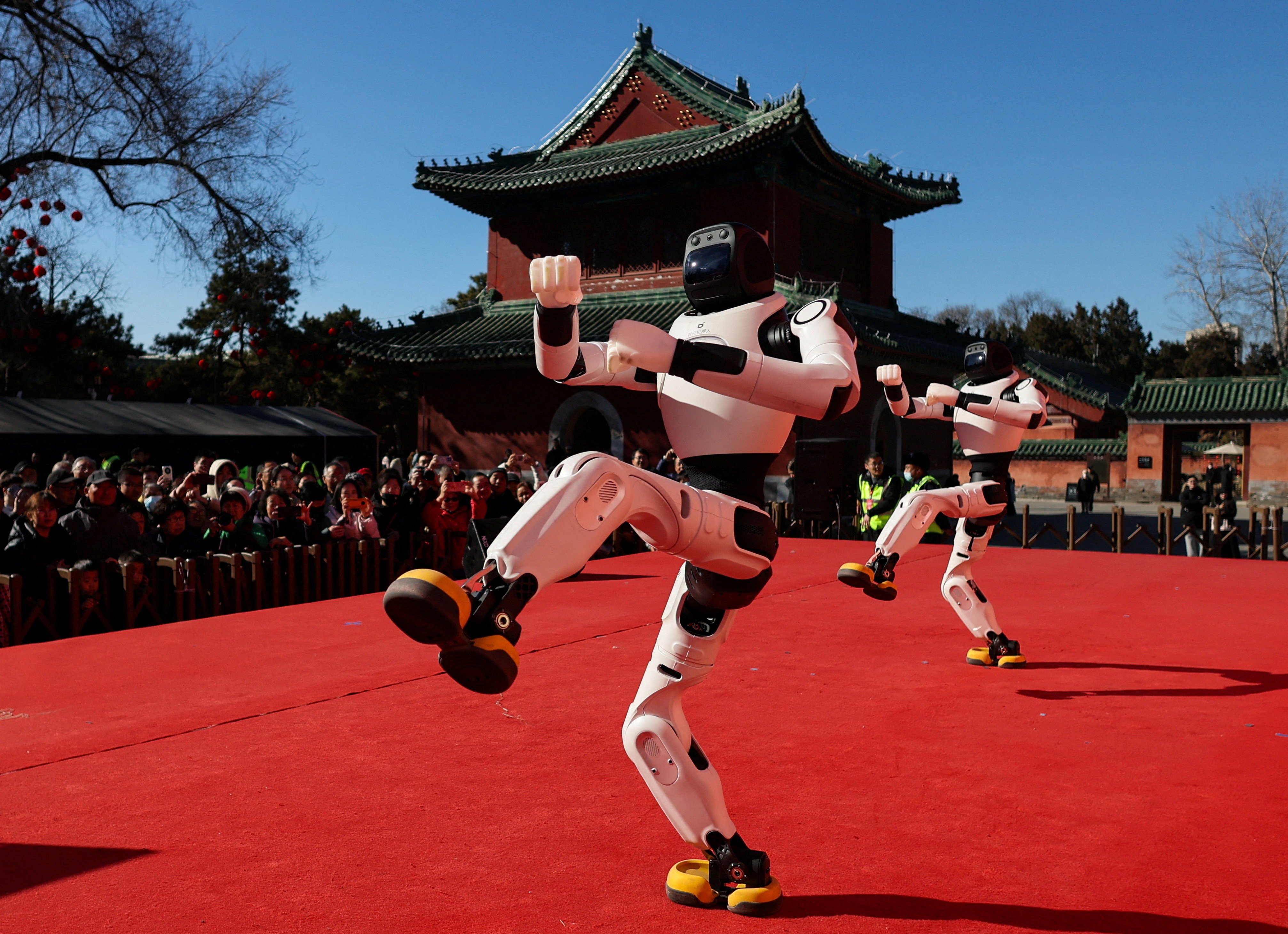People watch as robots perform a dance during Lunar New Year celebrations in Beijing on February 18. Photo: Reuters