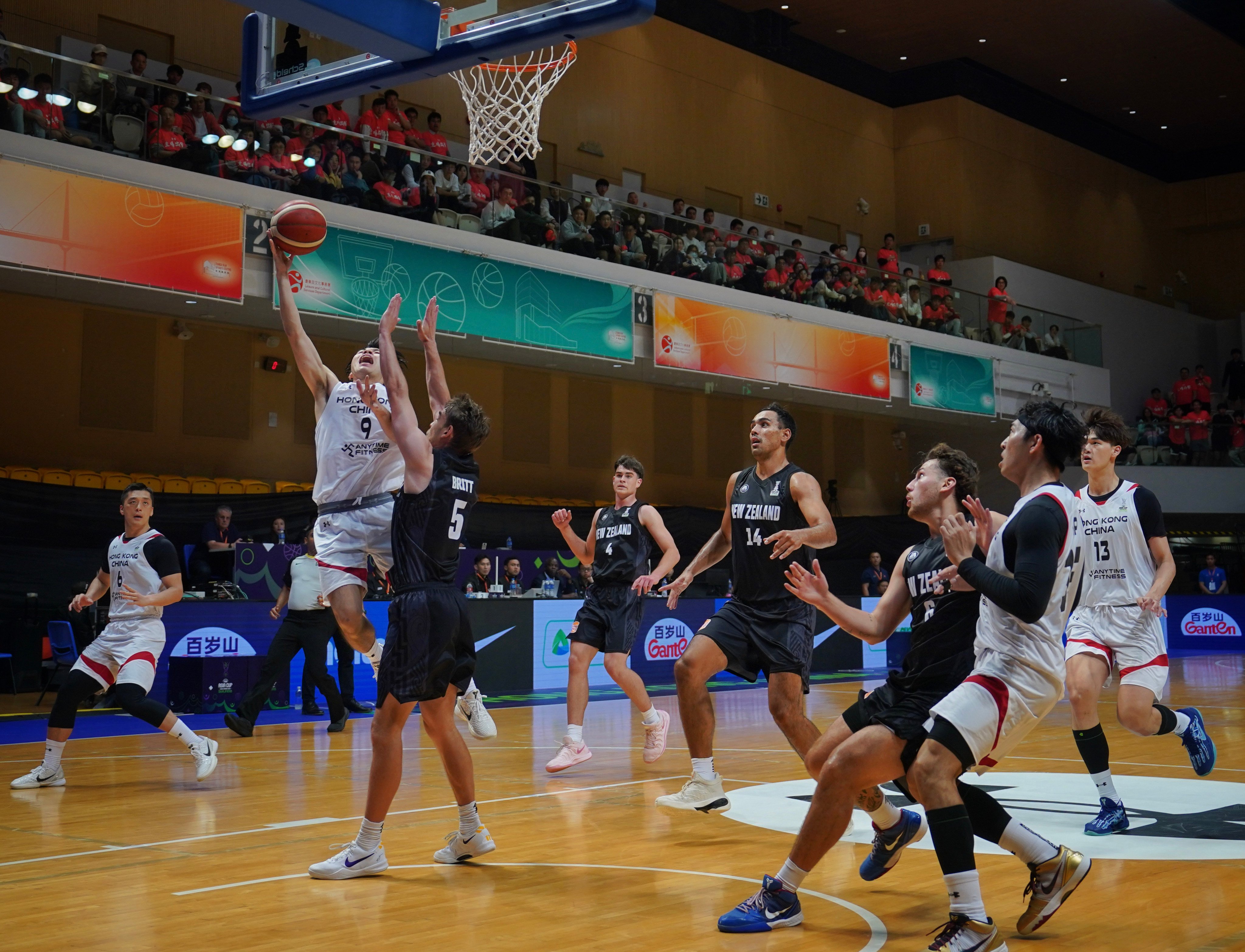 Hong Kong’s Tsang Cham-yuen tries to shoot against New Zealand’s Taylor Britt during their Fiba Asia Cup qualifier in February last year. Photo: Elson Li