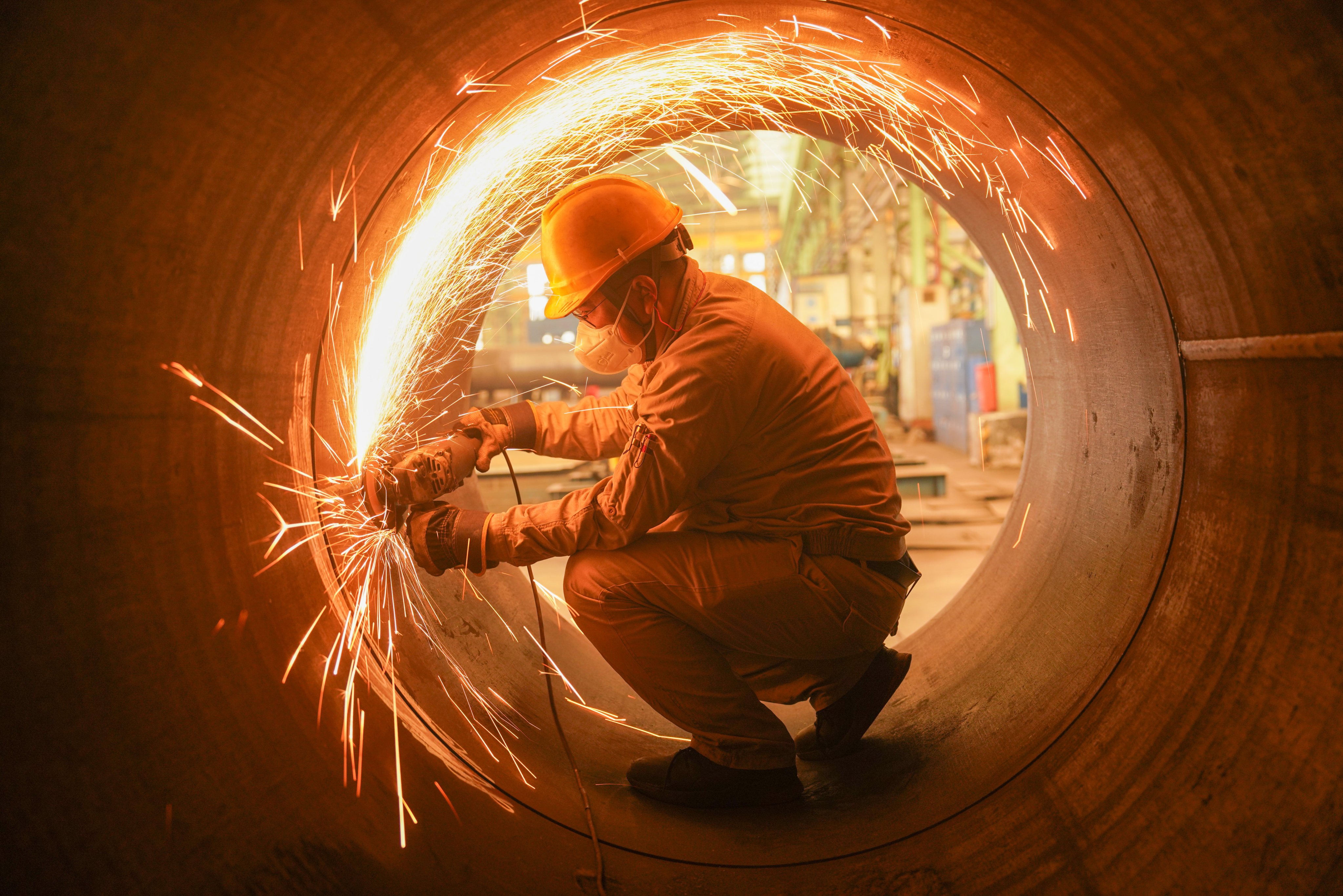 A worker uses machinery at a steel structure firm in China’s Sichuan province. China will raise the average duration of education for the working-age population to 11.7 years by 2030. Photo: Xinhua