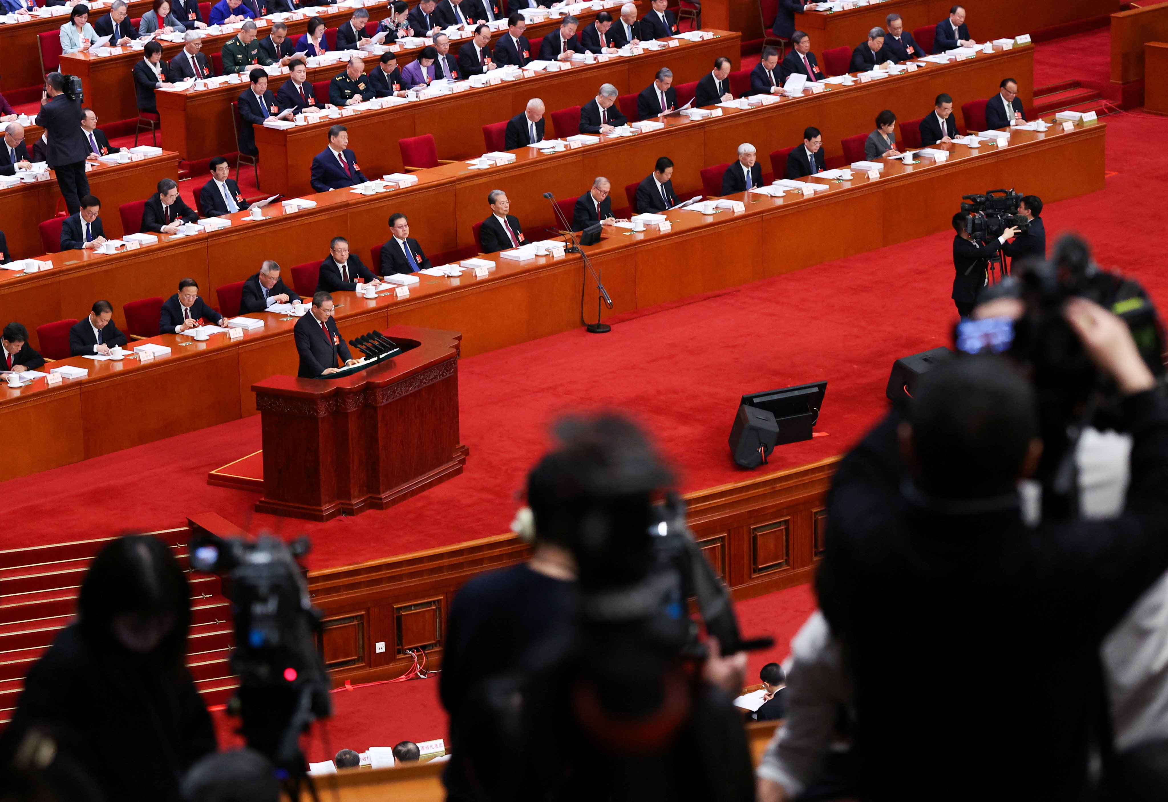 Journalists film as Chinese Premier Li Qiang delivers a work report during the opening session of the National People's Congress (NPC) at the Great Hall of the People in Beijing, China March 5, 2026. REUTERS/Maxim Shemetov