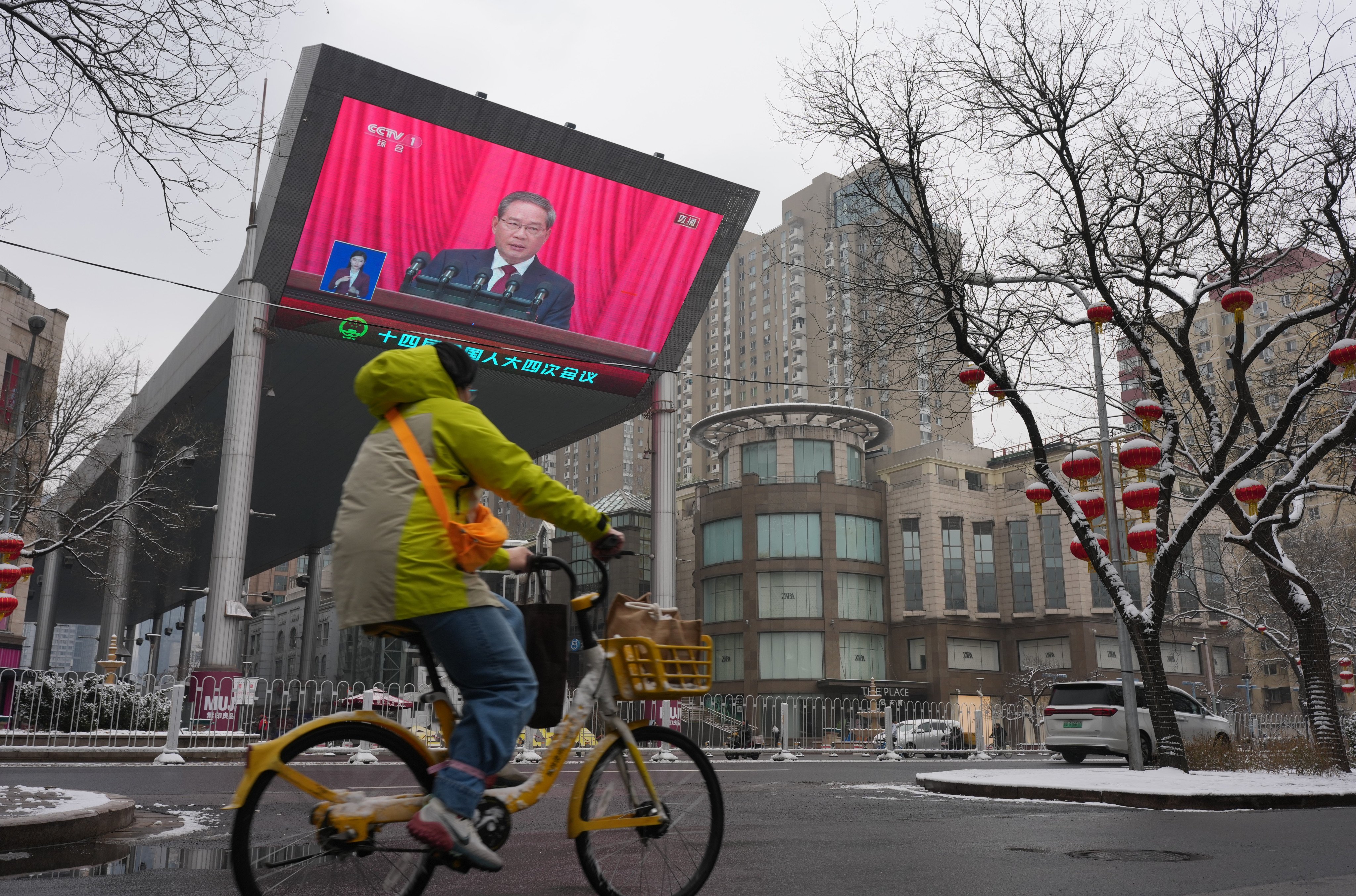 Premier Li Qiang’s speech is shown on a huge TV screen in Beijing. Photo: SCMP