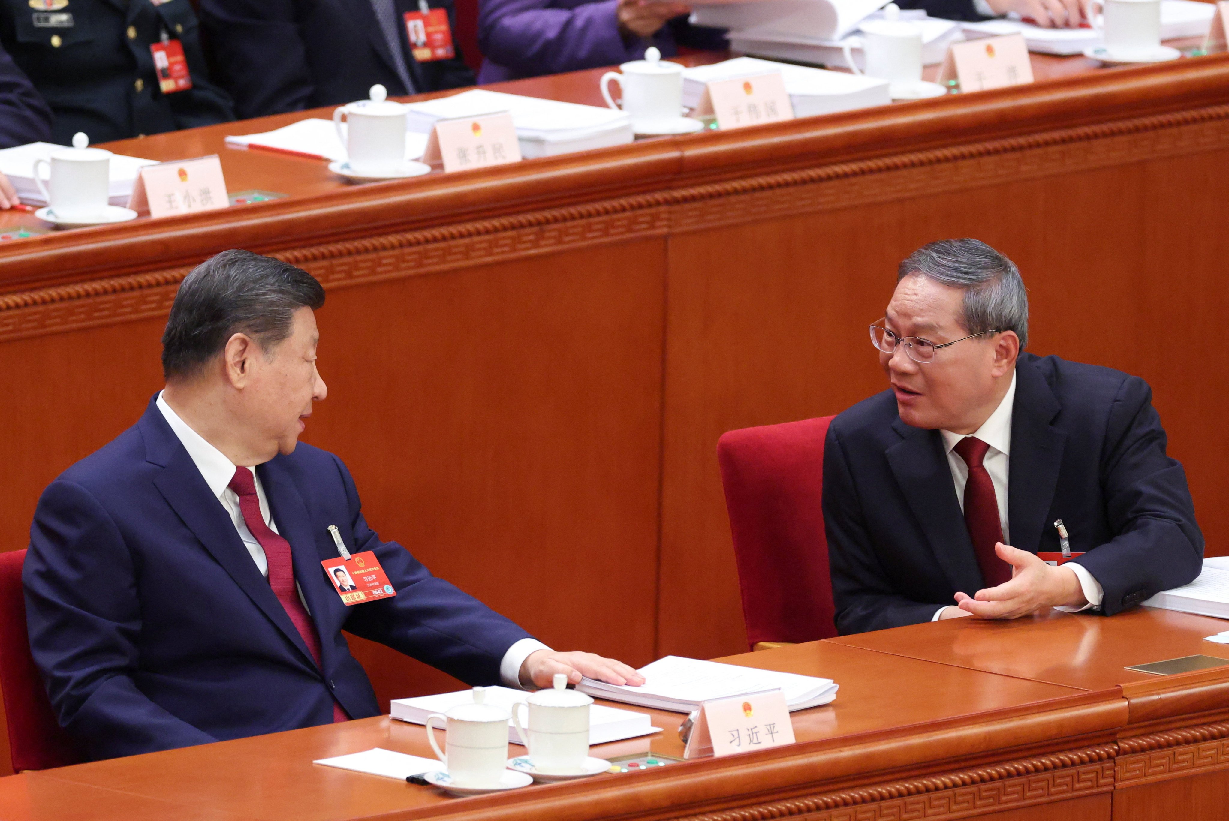 Chinese President Xi Jinping interacts with Chinese Premier Li Qiang during the opening session of the National People’s Congress (NPC) at the Great Hall of the People in Beijing, China March 5, 2026. Photo: Reuters