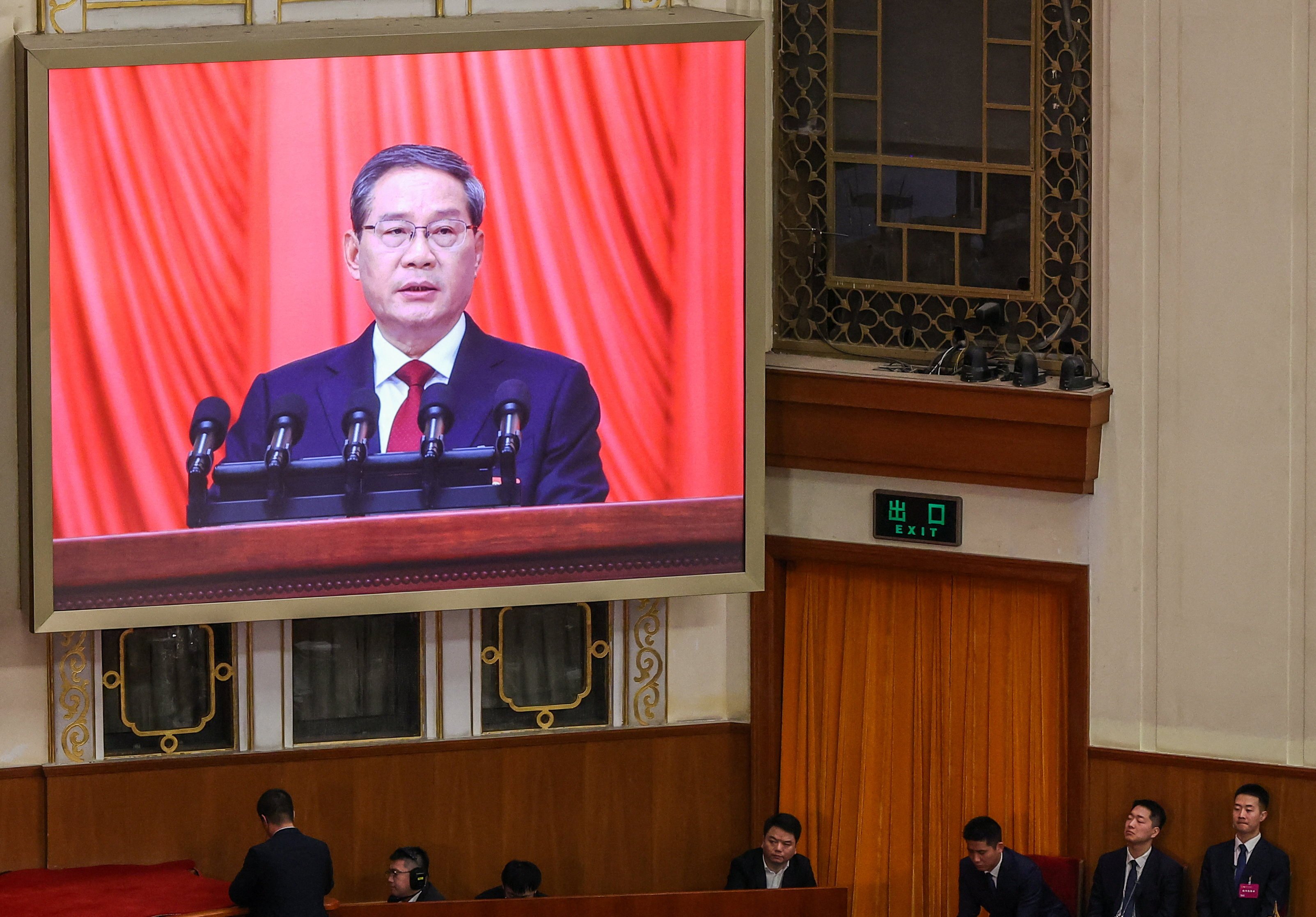 Premier Li Qiang is visible on a screen during the opening session of the National People’s Congress at the Great Hall of the People in Beijing on Thursday. Photo: Reuters