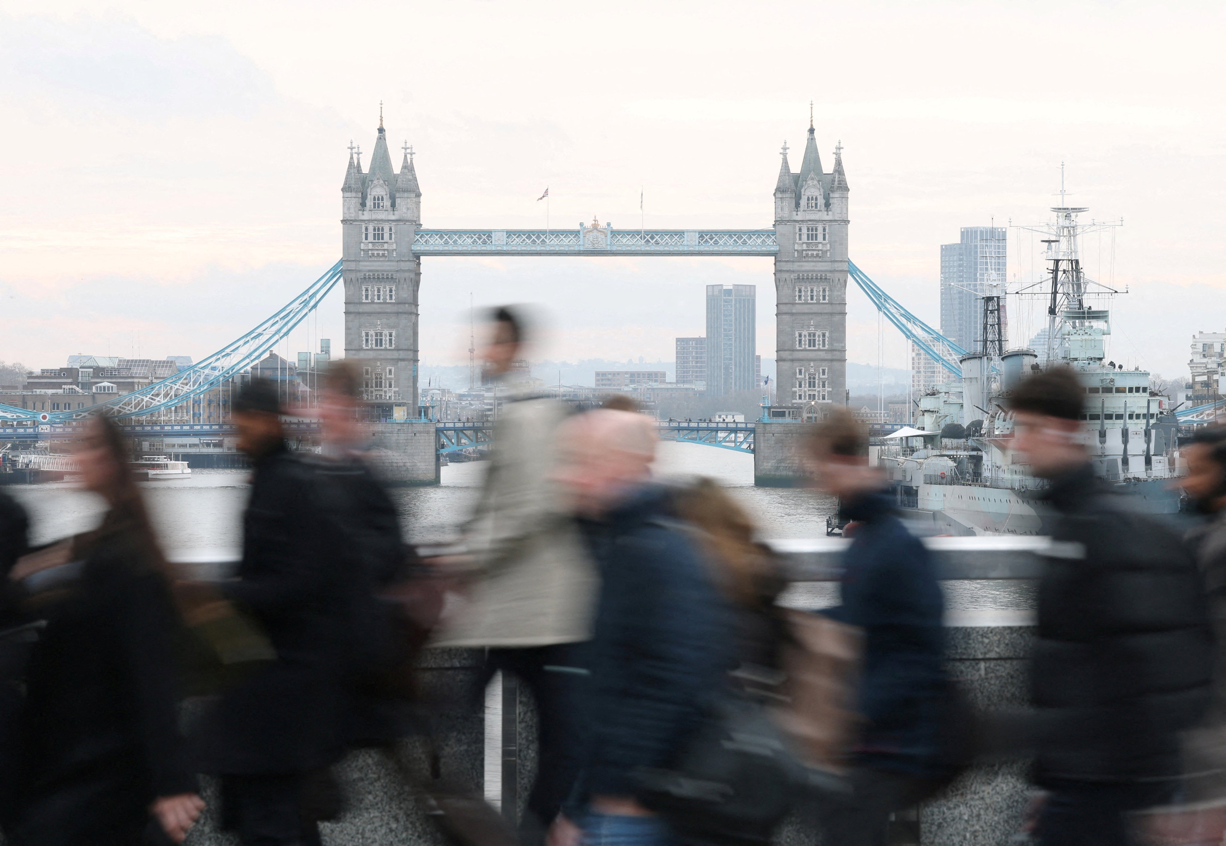 Workers cross London Bridge during the morning rush-hour. Photo: Reuters
