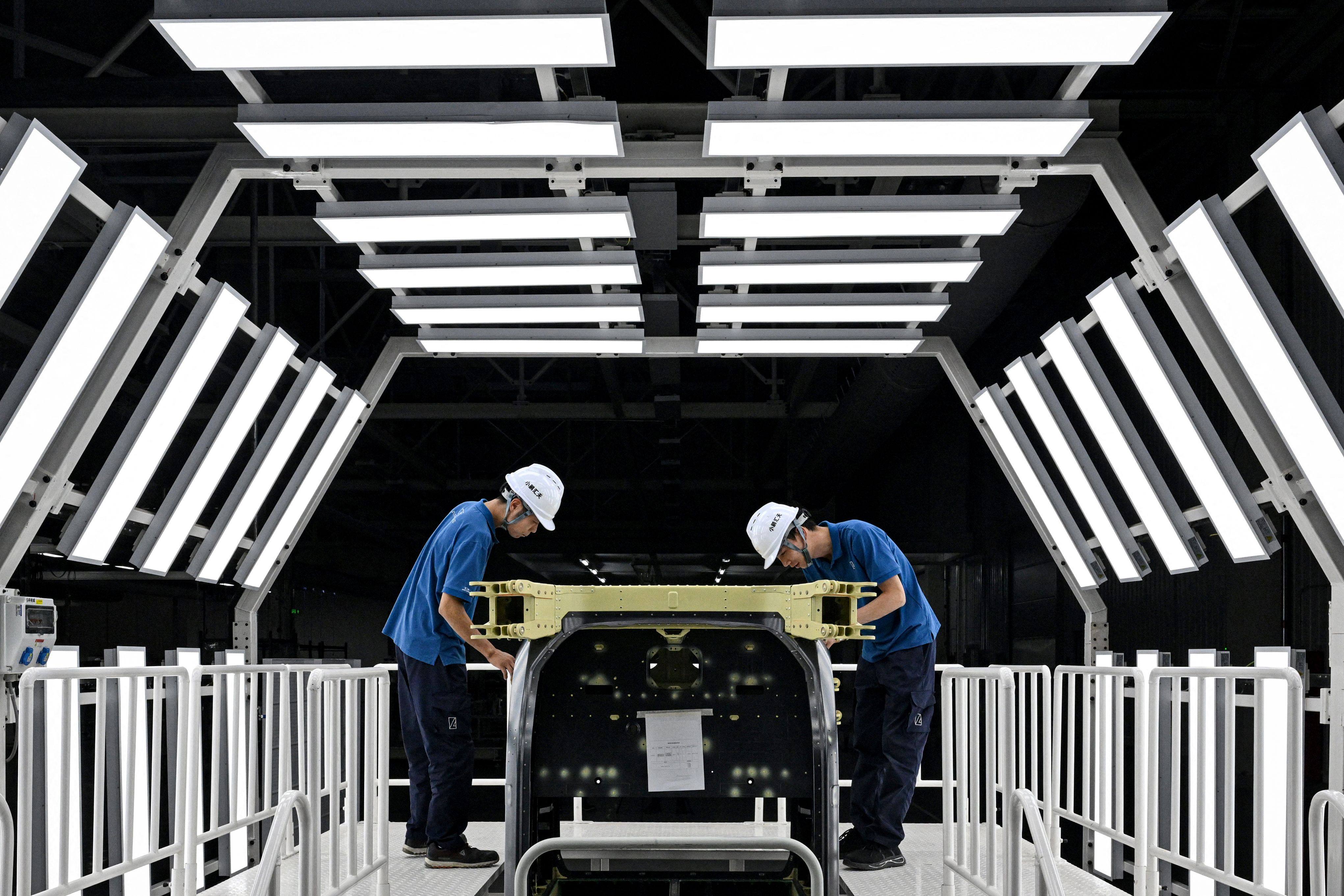 Employees work on a production line for electric flying cars in the southern Chinese city of Guangzhou. Photo: AFP