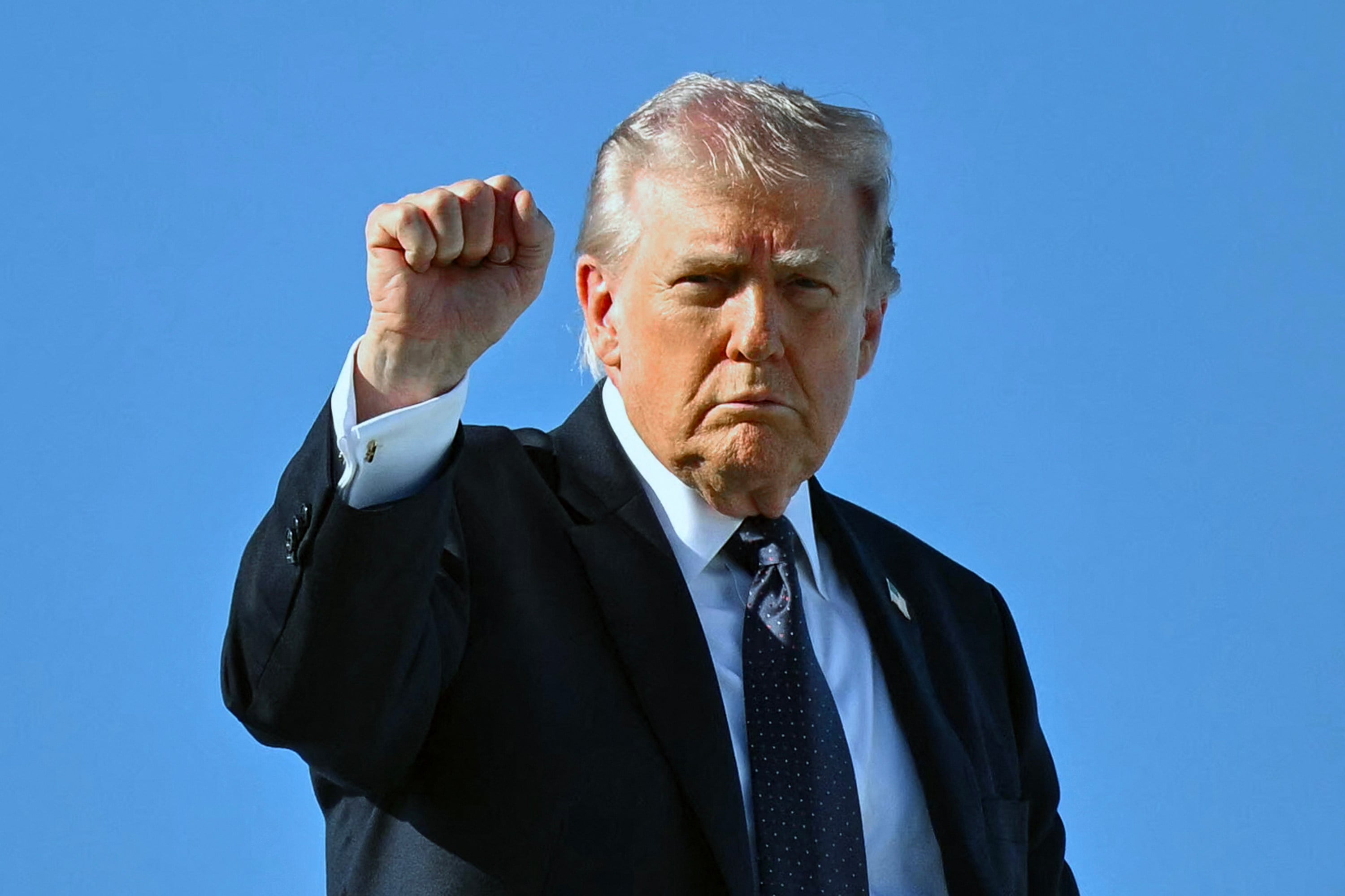 US President Donald Trump gestures as he boards Air Force One before departing leaving Palm Beach International Airport in Florida on Sunday. Photo: AFP/TNS
