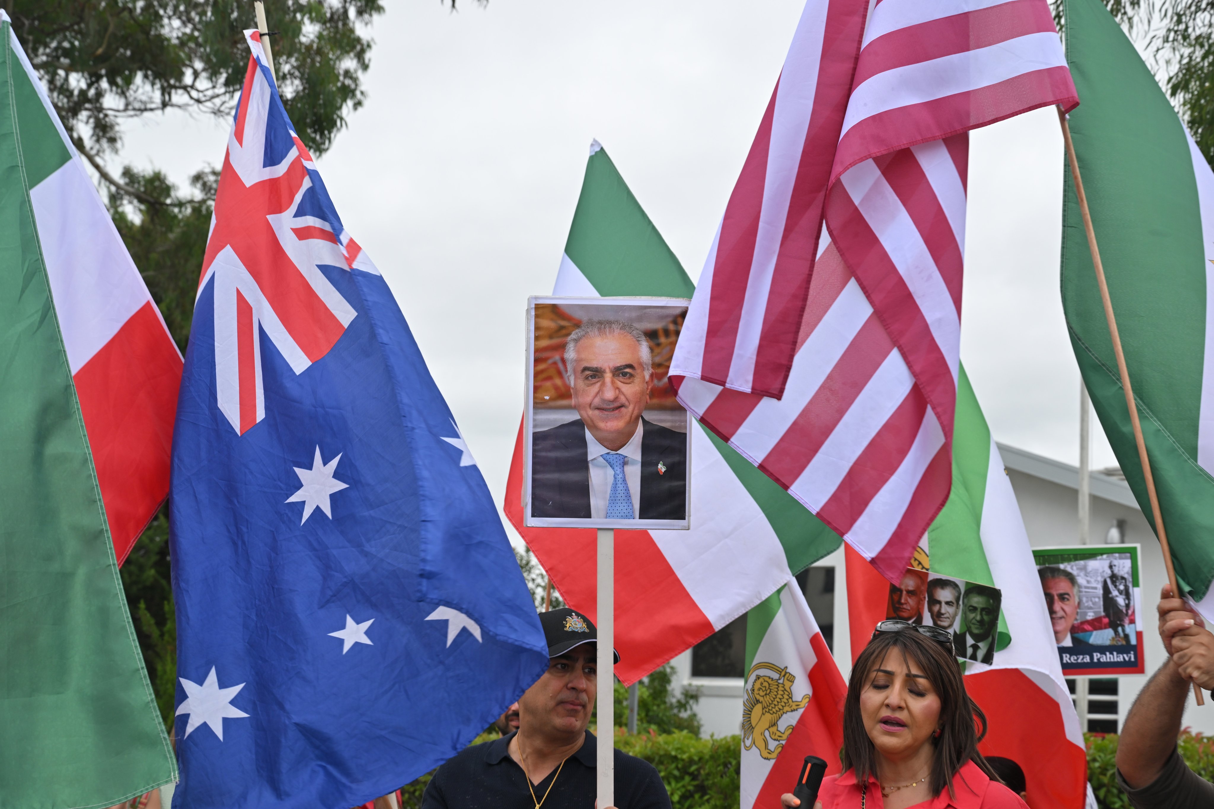 Members of the Iranian diaspora in Australia celebrate US and Israeli military strikes on Iran outside Iranian embassy in Canberra on March 1. Photo: EPA