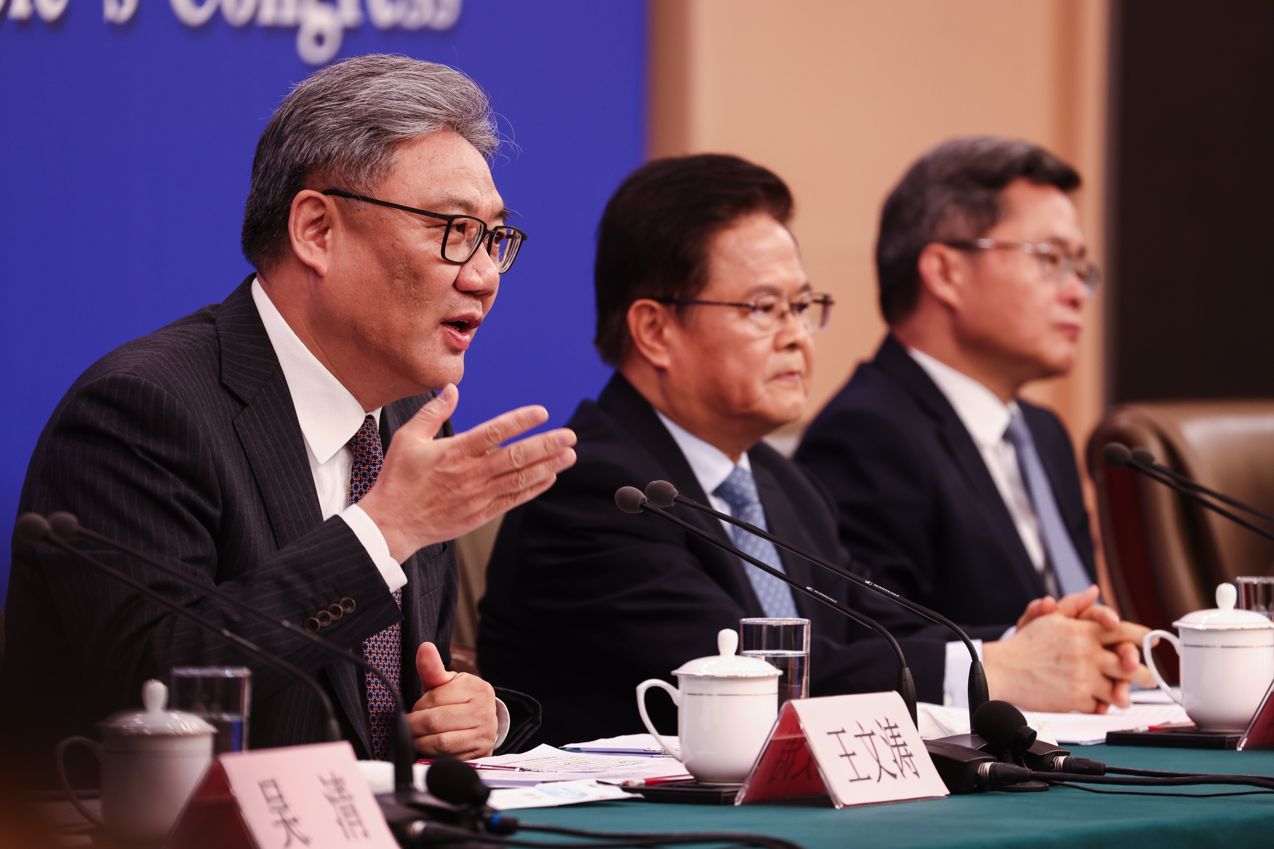 Chinese Minister of Commerce Wang Wentao, left, speaks during a press conference on the economy in Beijing. Photo: EPA