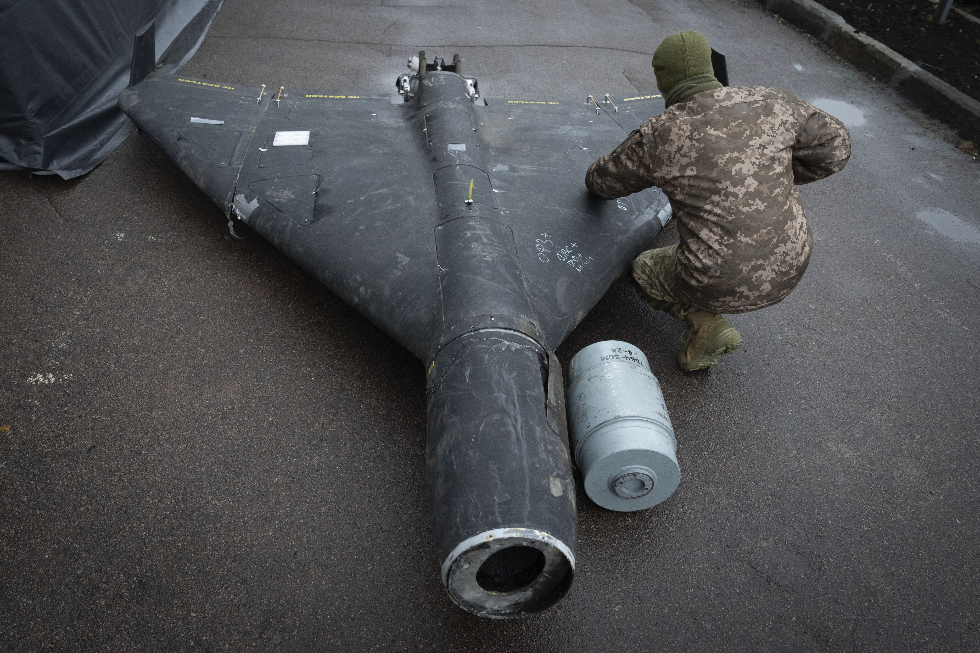 A Ukrainian officer examines a downed Shahed drone at an undisclosed location in Ukraine in November 2024. Photo: AP