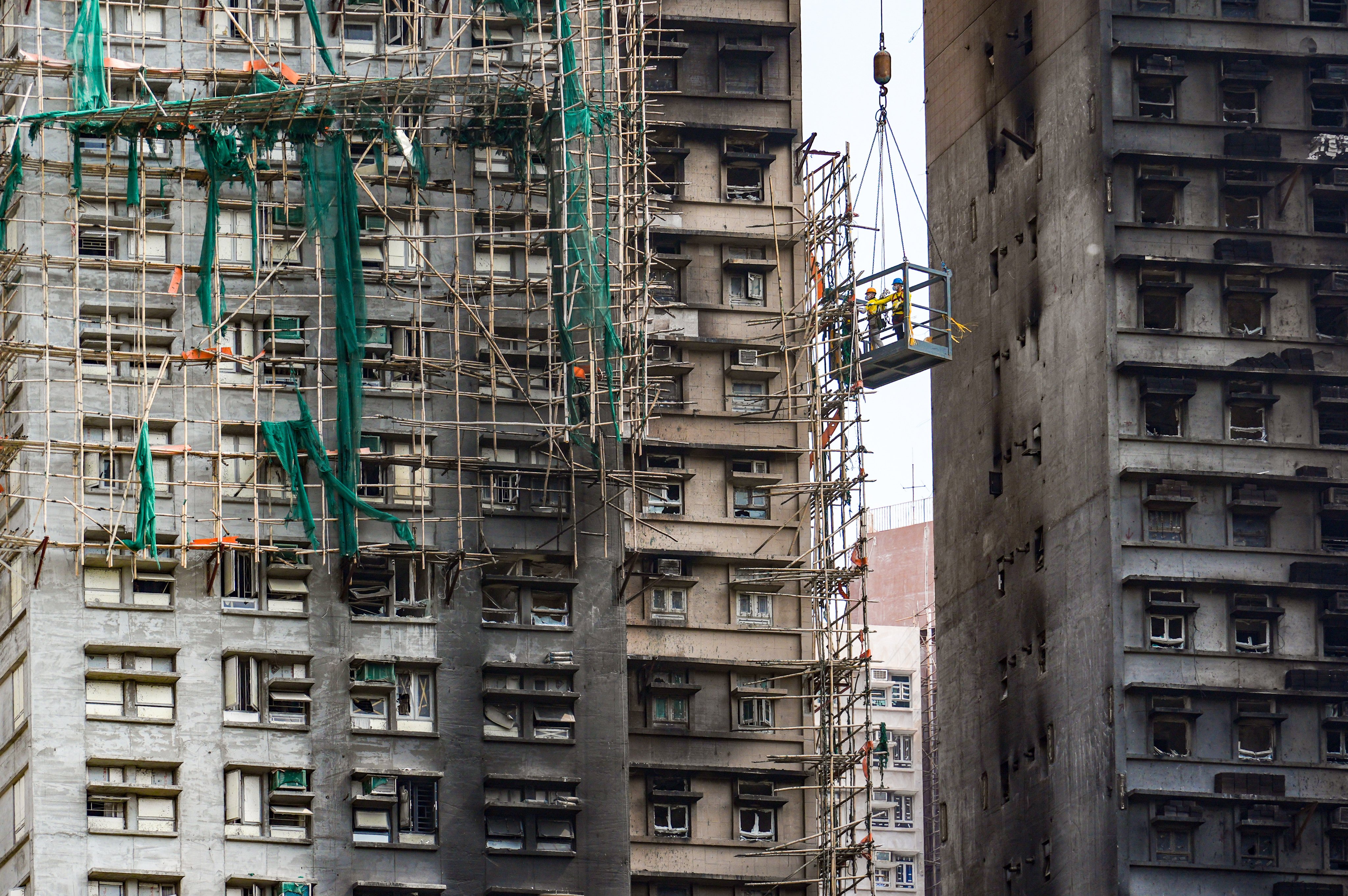 Workers dismantle bamboo scaffolding at Wang Fuk Court in Tai Po last month. Photo: Eugene Lee