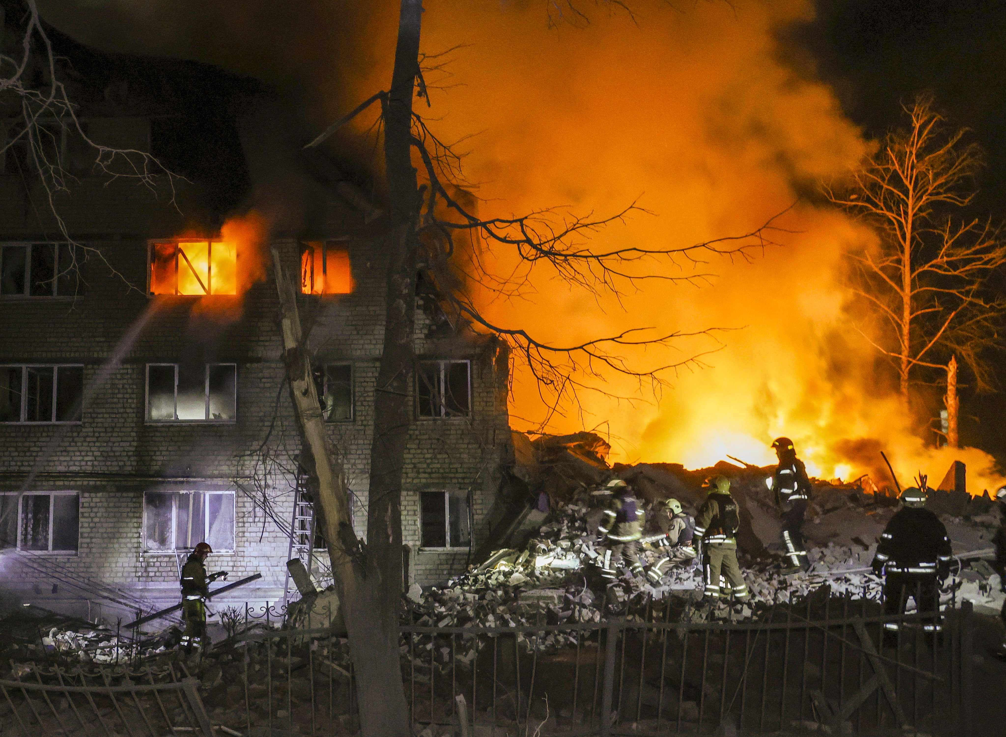 Rescuers work at the site of a fatal missile strike on a residential building in Kharkiv, Ukraine, on Saturday. Photo: EPA