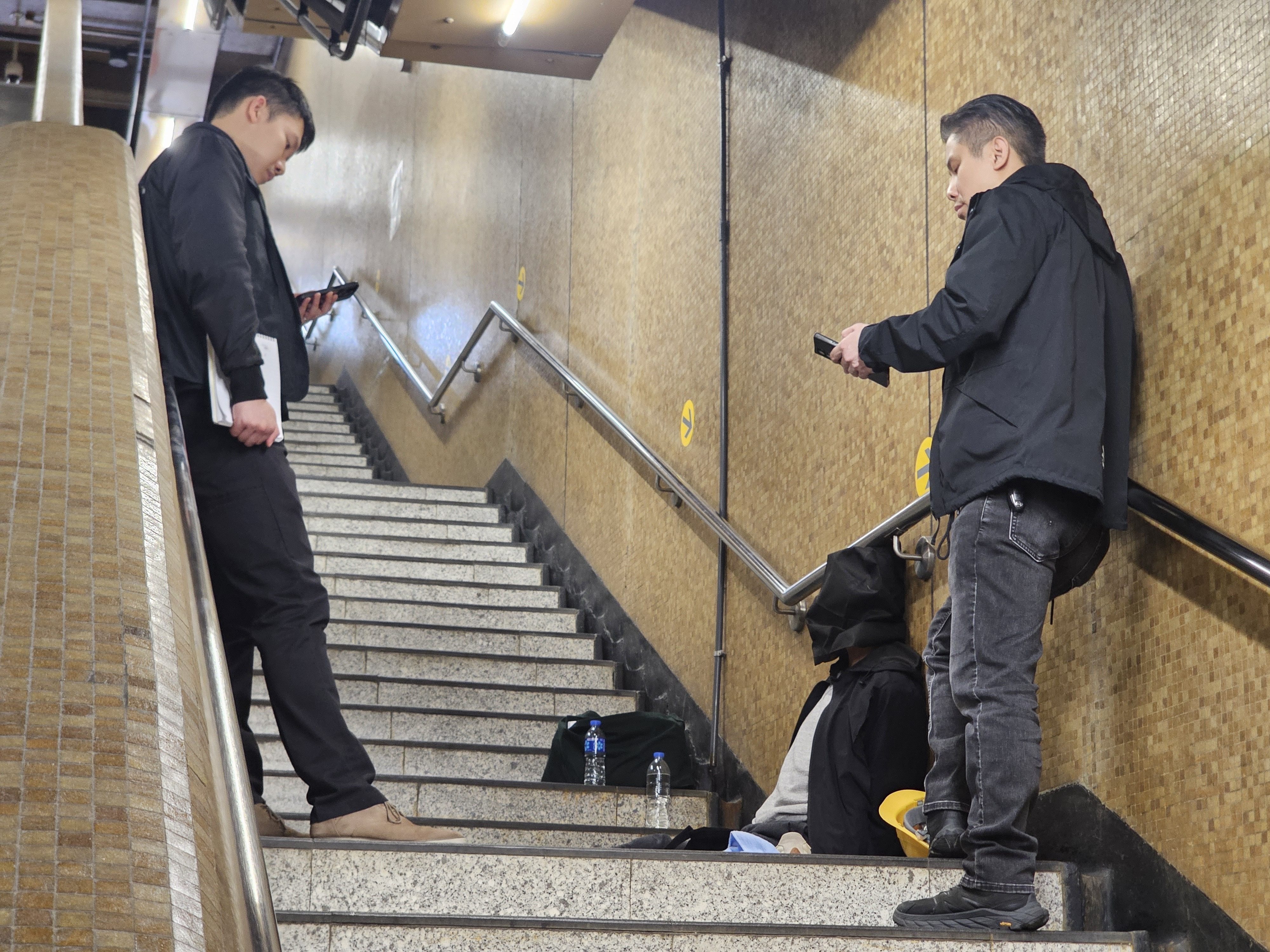 Police with a suspect taken into custody on Friday. Photo: Handout