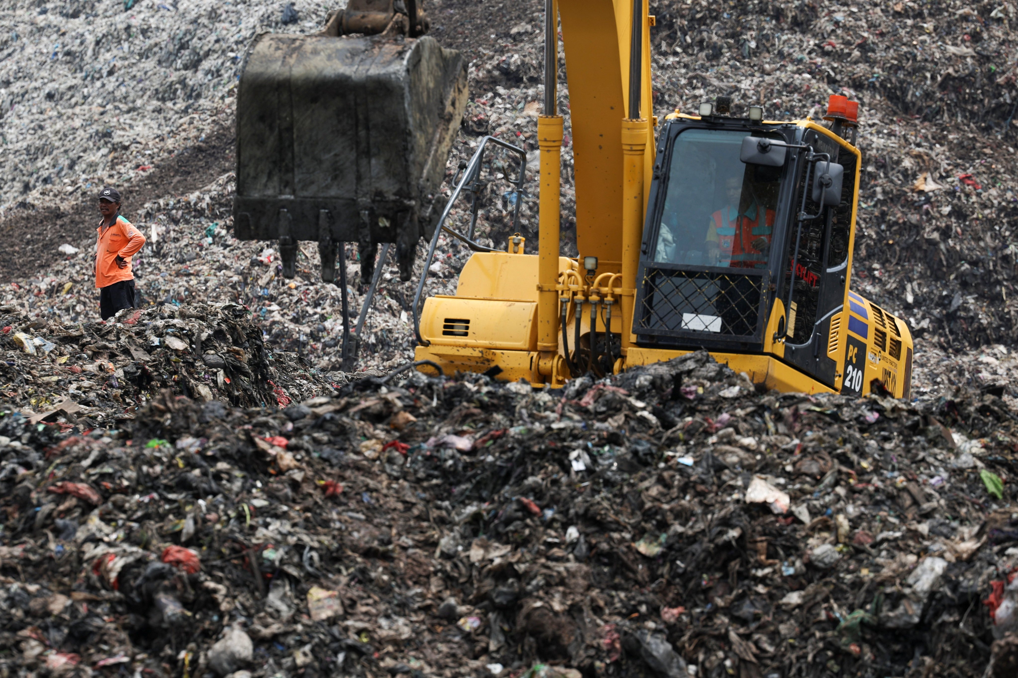 A worker stands amid rubbish at the site of a collapse at the Bantargebang landfill during a rescue operation in Bekasi, on the outskirts of Jakarta, on Sunday. Photo: Reuters