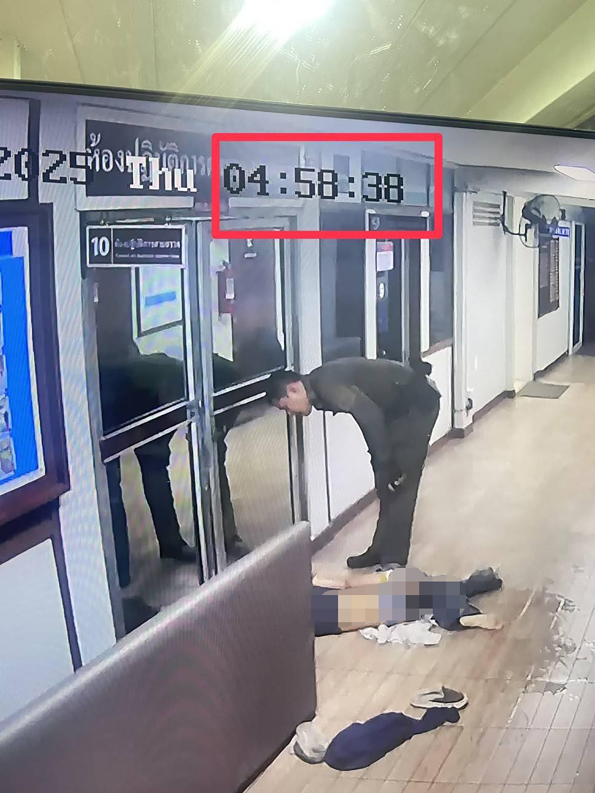 A Thai officer interacts with a woman who was brought to a police station instead of a hospital following a motorcycle crash in Bangkok. Photo: Facebook / anuwatf.ch7