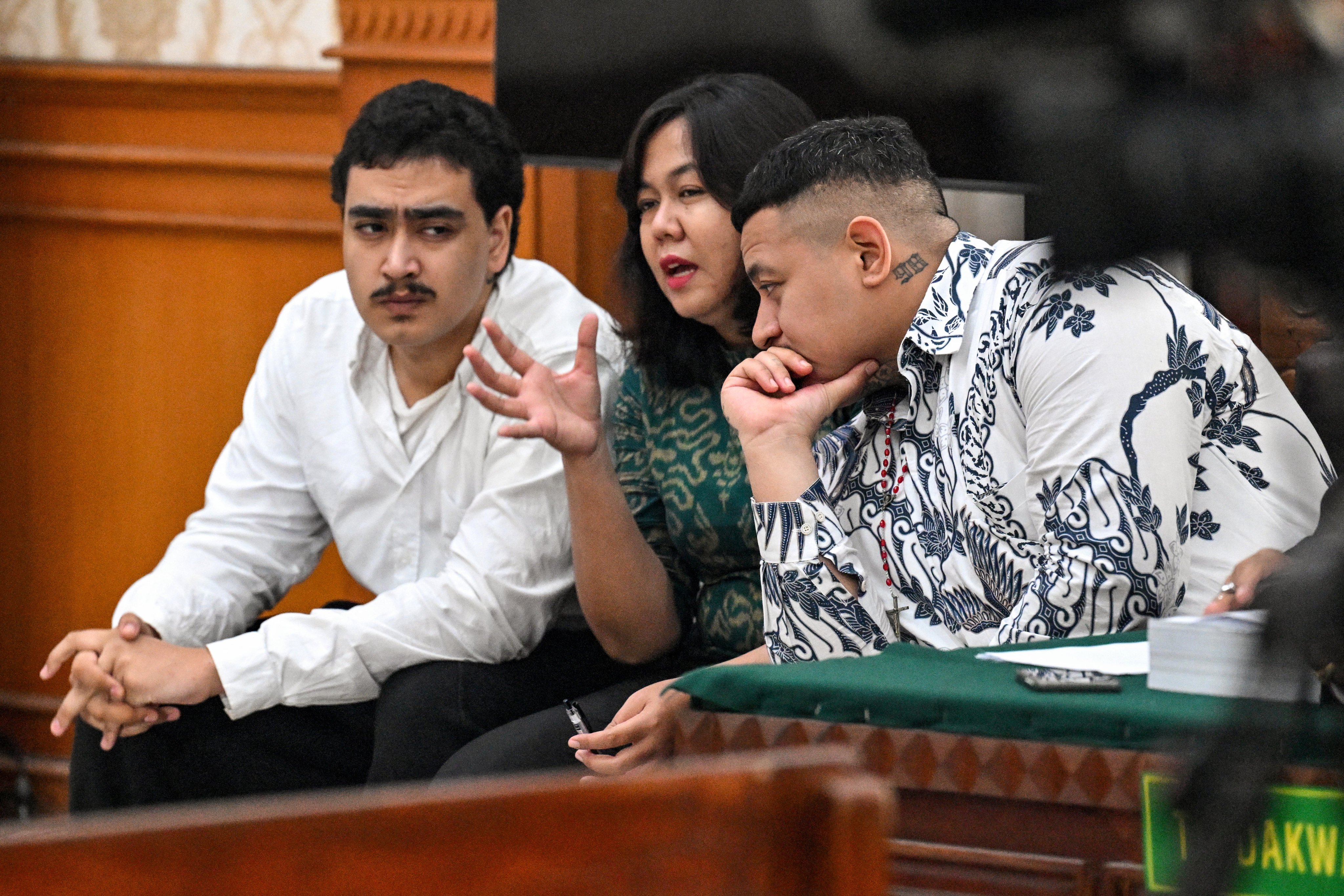 Australian suspect Paea-I-Middlemore Tupou (R) and Australian suspect Mevlut Coskun (L) attend a hearing as part of a trial at a courtroom in Denpasar on Indonesia’s resort island of Bali on December 1, 2025. The trial of three Australians accused of plotting the murder of a compatriot at a villa in Bali continues, with all facing the death penalty. (Photo by SONNY TUMBELAKA / AFP)