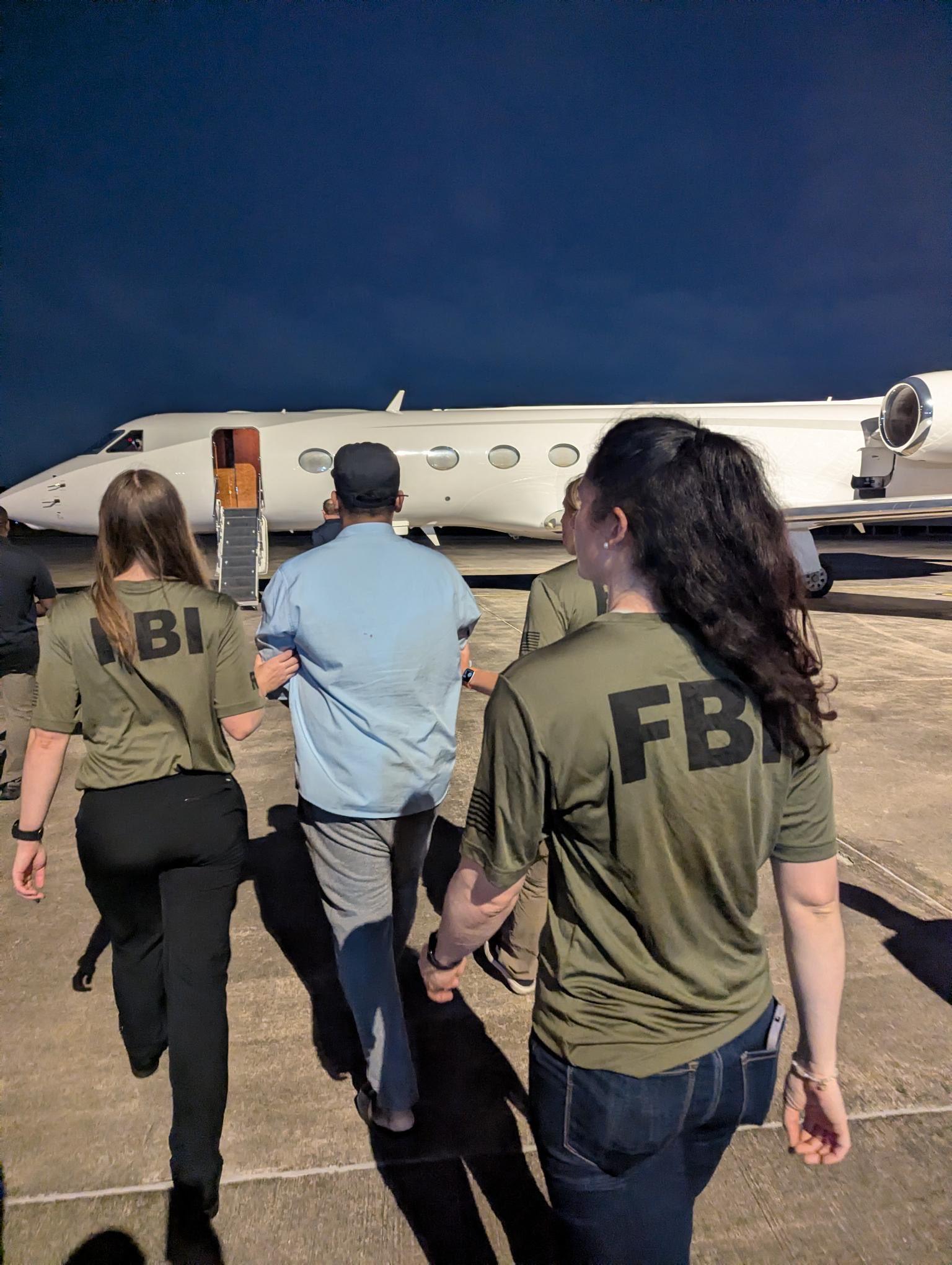 Bangladeshi national Zobaidul Amin is escorted to an aircraft by FBI agents. Photo: X / FBI Director Kash Patel