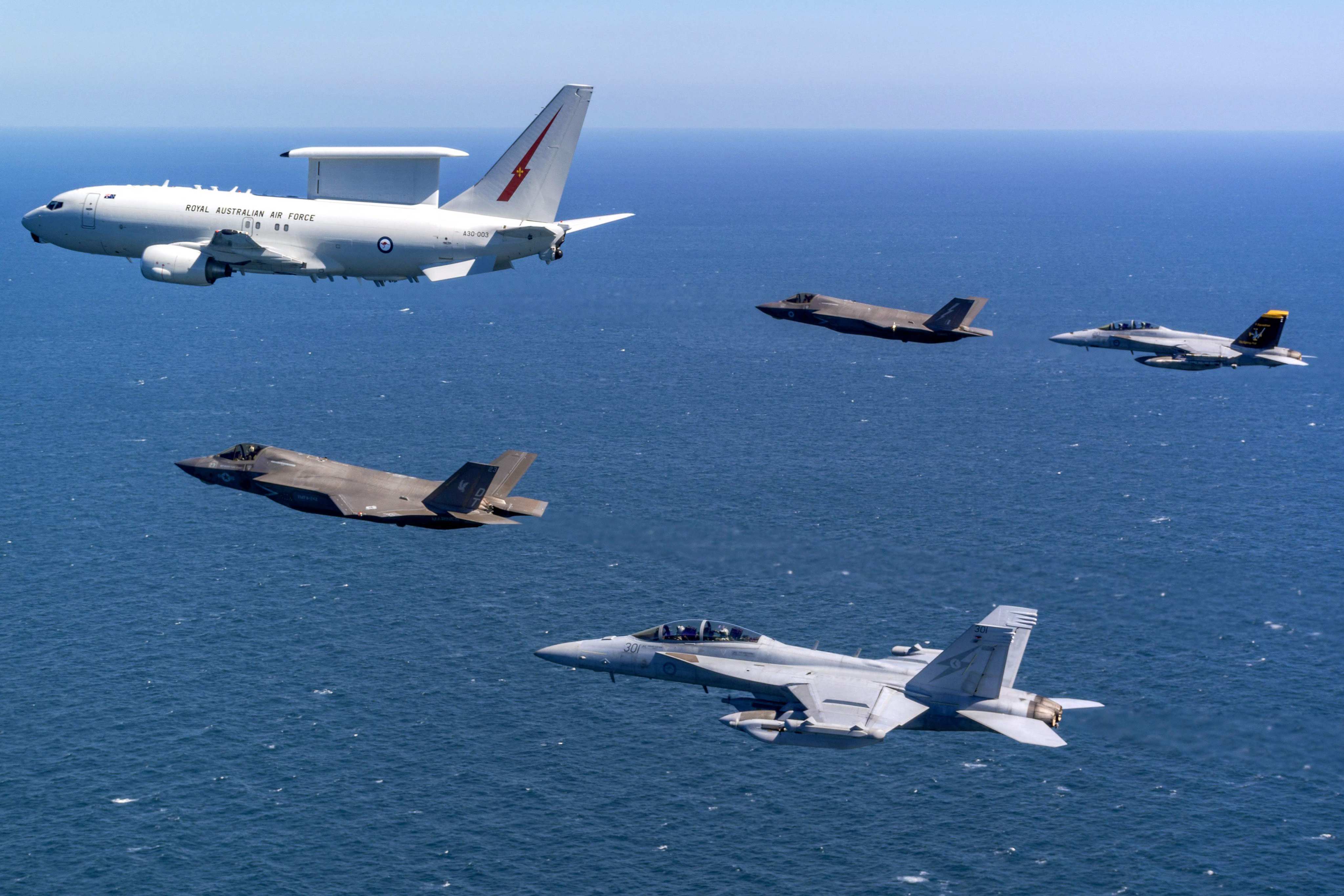 A Royal Australian Air Force E-7A Wedgetail aircraft in formation with US and Australian fighter jets. Photo: Australian Defence Force via AFP