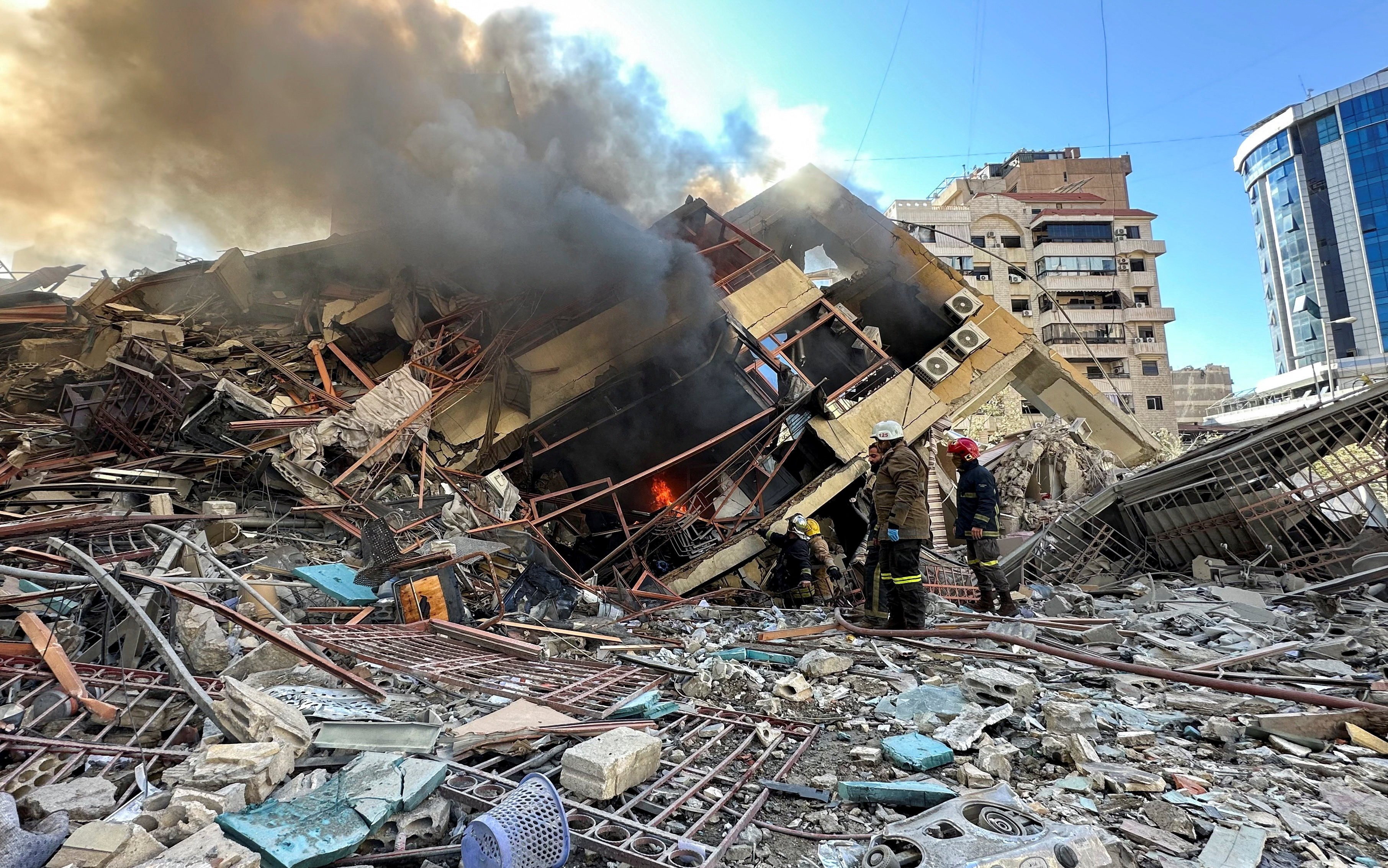 Members of the Lebanese Civil Defence inspect a damaged building after an Israeli strike on Beirut’s southern suburbs. Photo: Reuters