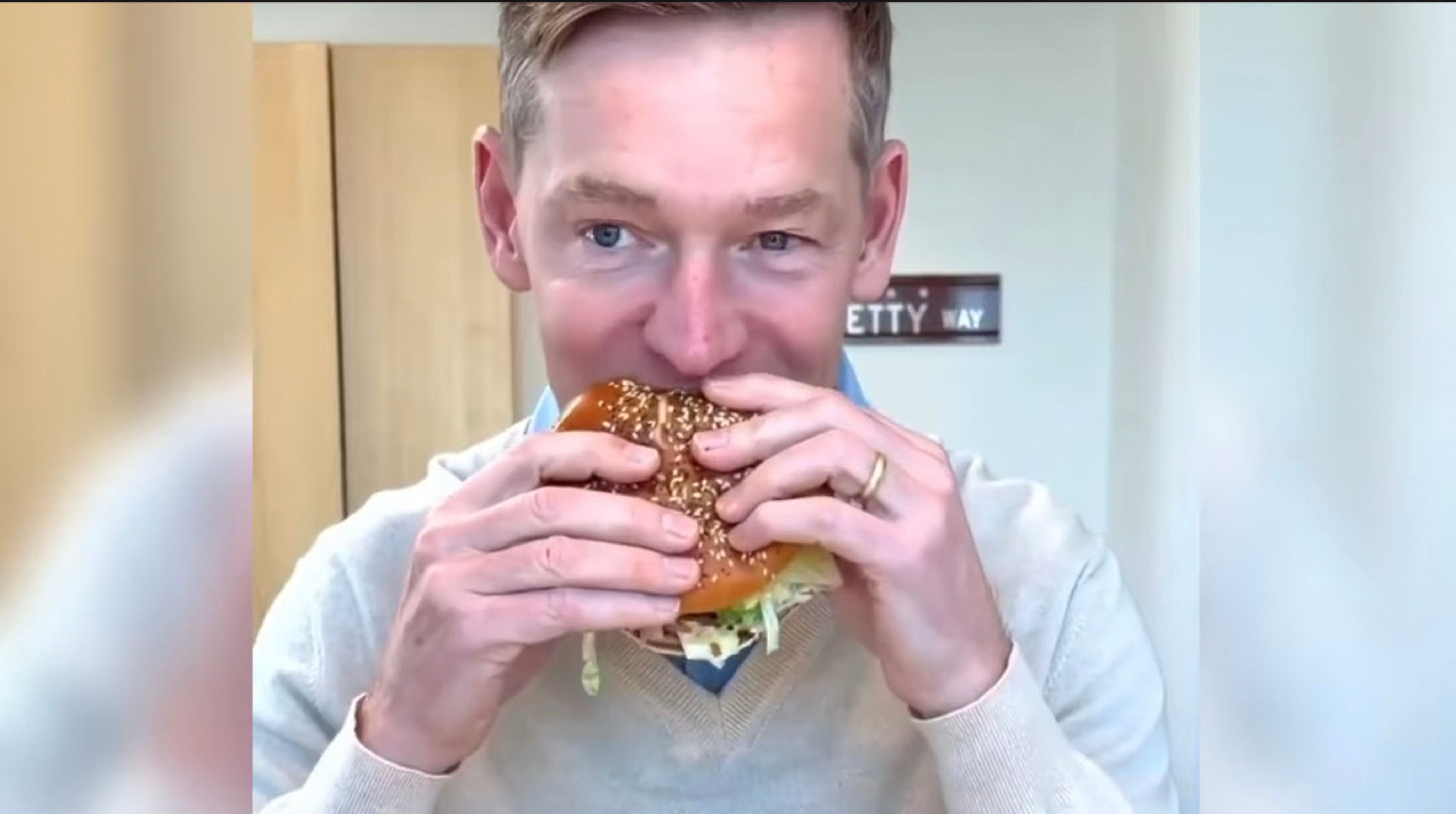 McDonald’s CEO Chris Kempczinski takes a bite of the fast food chain’s new Big Arch burger in a recent social media video posted by the company. Photo: YouTube