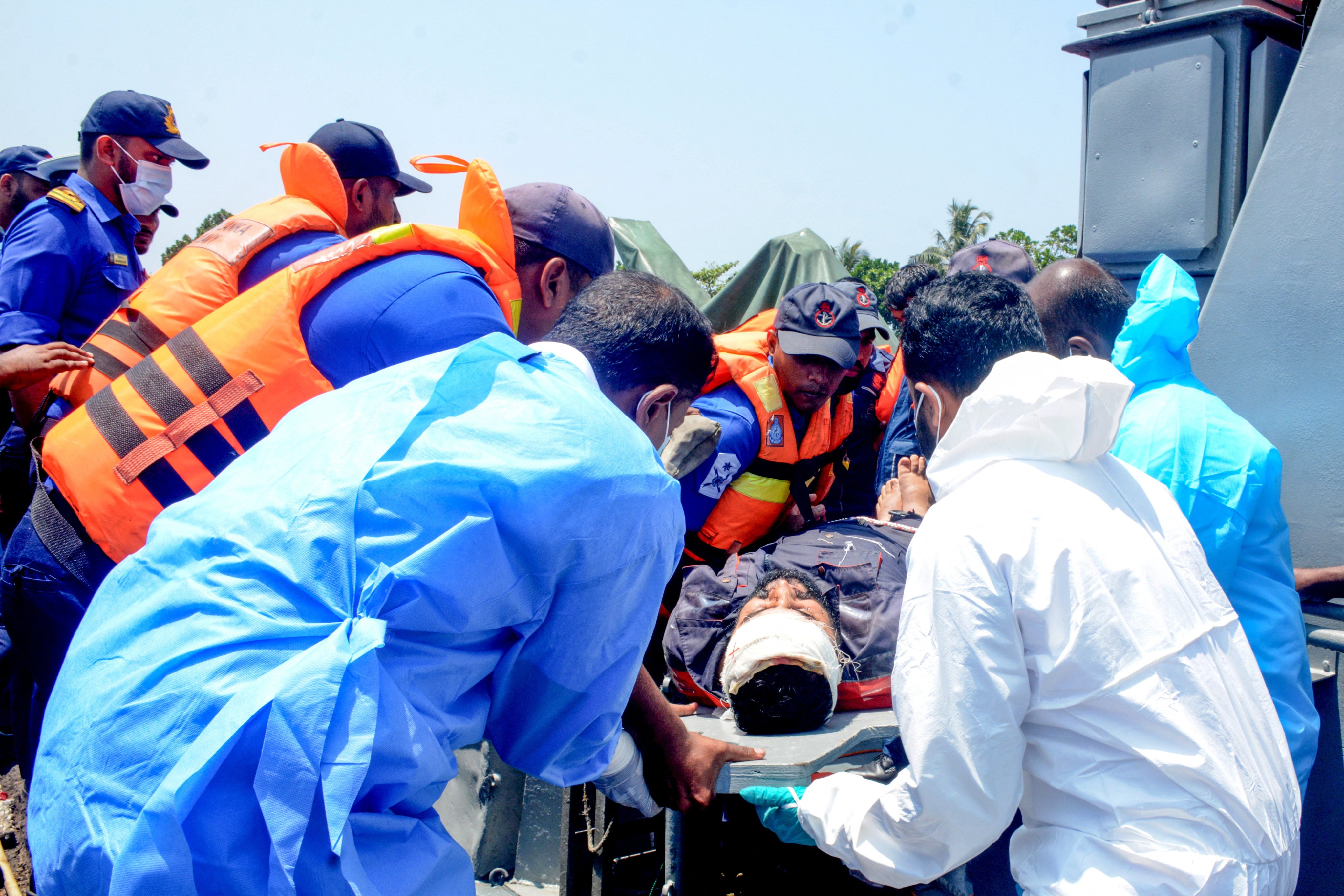Medical personnel and Sri Lanka Navy sailors provide emergency treatment to an injured Iranian rescued from the IRIS Dena on March 4. Photo: Sri Lanka Navy/Reuters